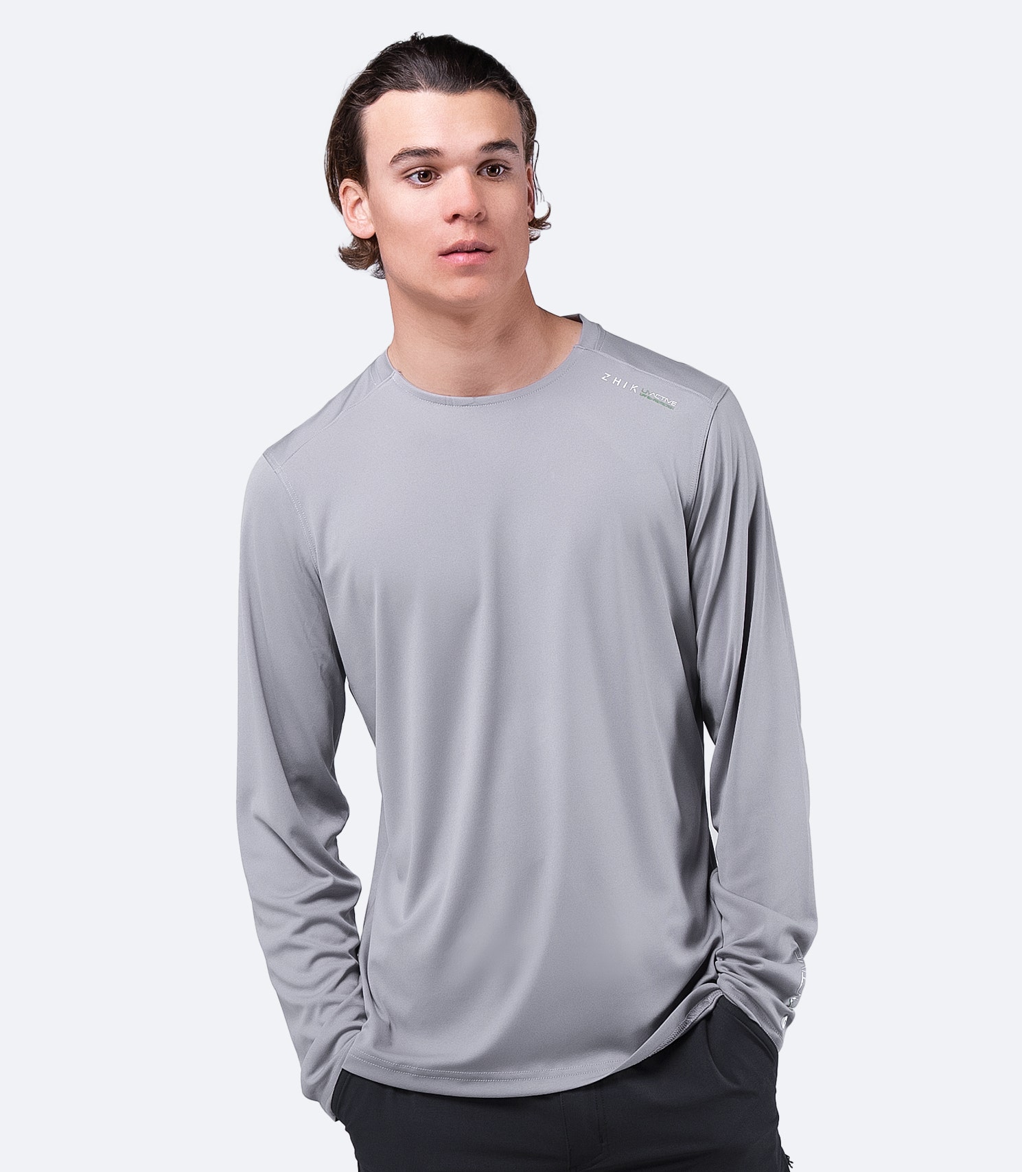 Front view of Zhik Men's UVactive Long Sleeve Top in grey, highlighting lightweight, durable polyester knit.
