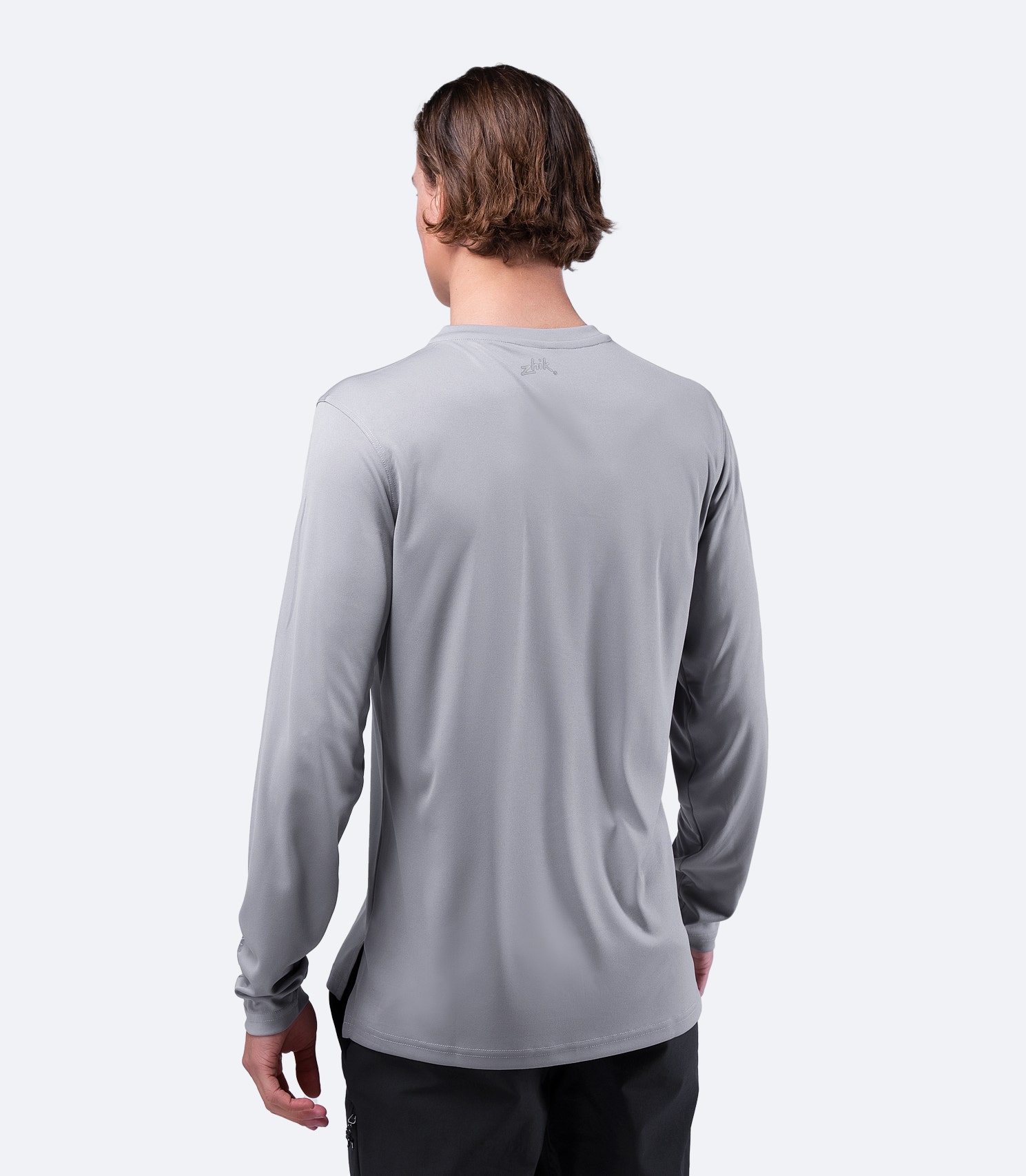 Rear view of Zhik Men's UVactive Long Sleeve Top in grey, showcasing moisture-wicking and quick-dry technology.