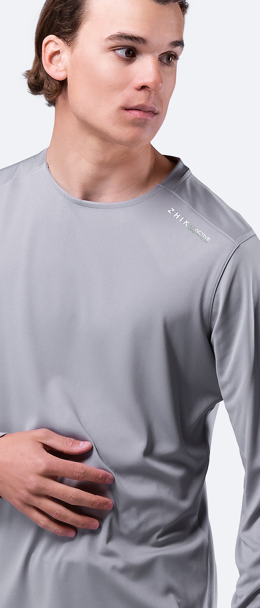 Detailed view of grey Zhik Men's UVactive Top, highlighting collar construction and breathable polyester knit.