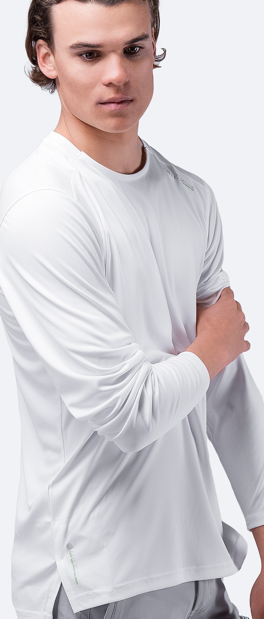 Side view of Zhik Men's UVactive Long Sleeve Top in white, emphasizing lightweight and anti-static comfort.