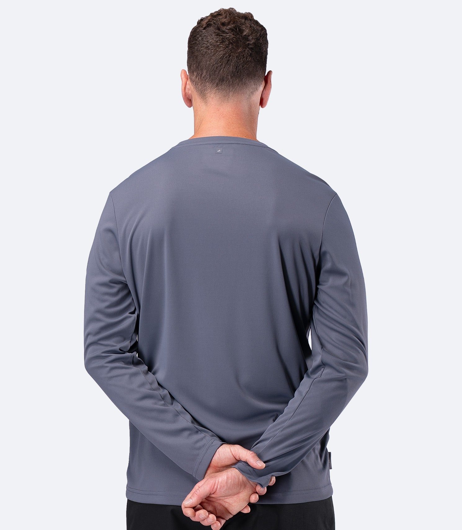 Back view of Zhik Men's UVActive Long Sleeve Tech Top in Slate, showing full arm coverage for sun protection