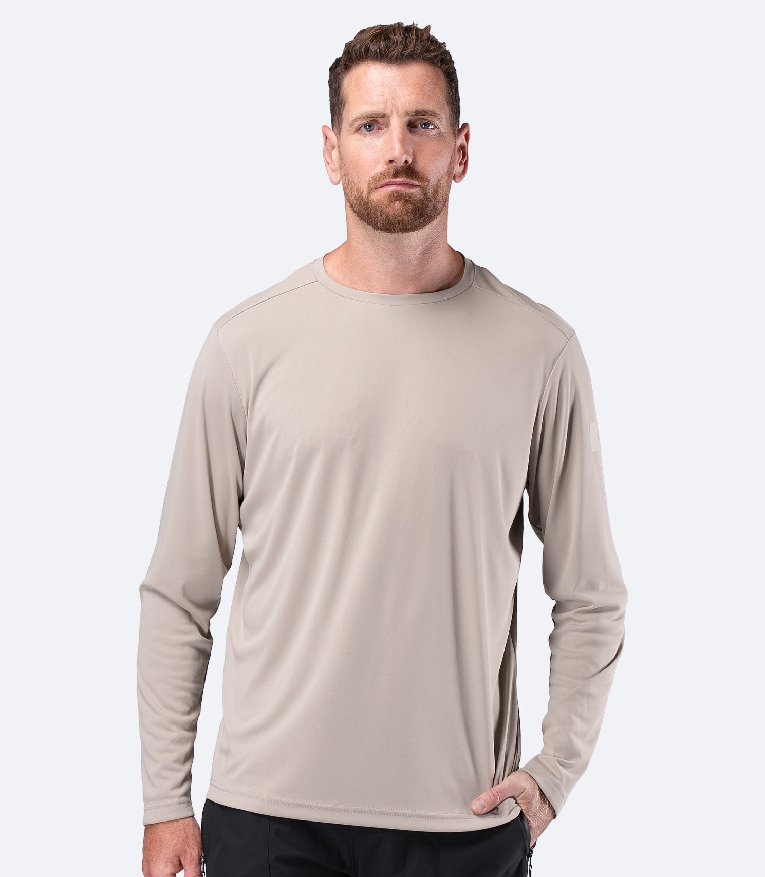 Front view of Zhik Men's UVActive Long Sleeve Tech Top in Stone, lightweight recycled polyester layer
