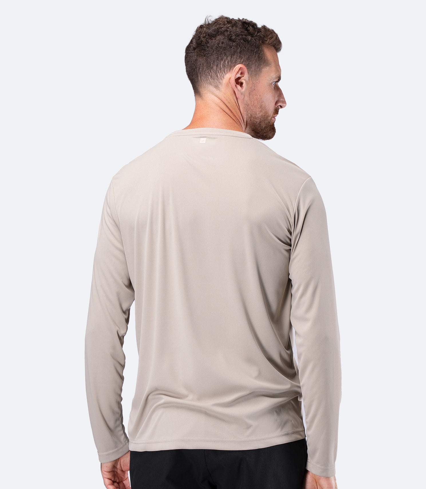 Back view of Zhik Men's UVActive Long Sleeve Tech Top in Stone, showing full arm coverage for sun protection