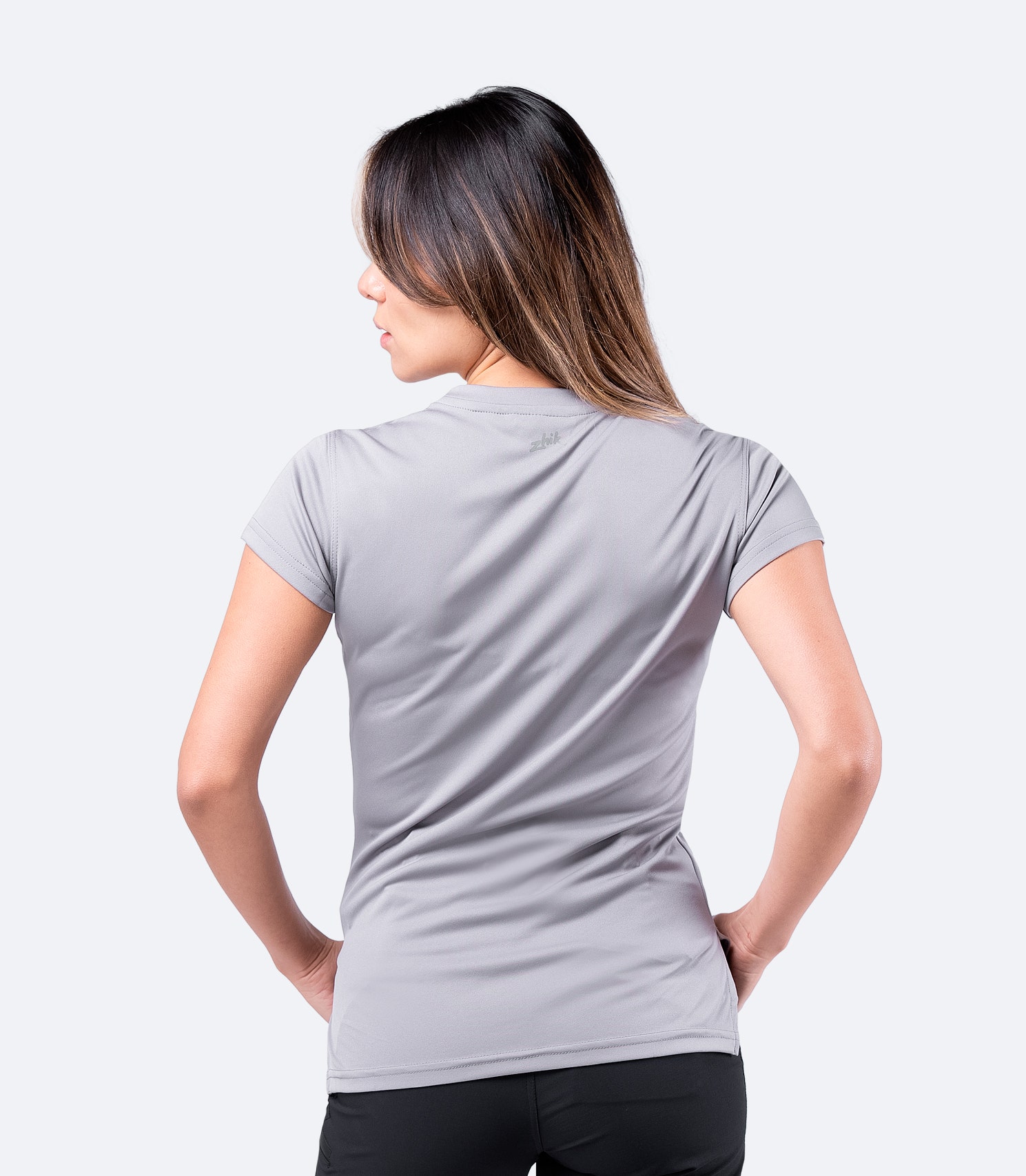 Back view of grey Zhik Women's UVActive Short Sleeve Top, showcasing moisture-wicking polyester knit fabric.
