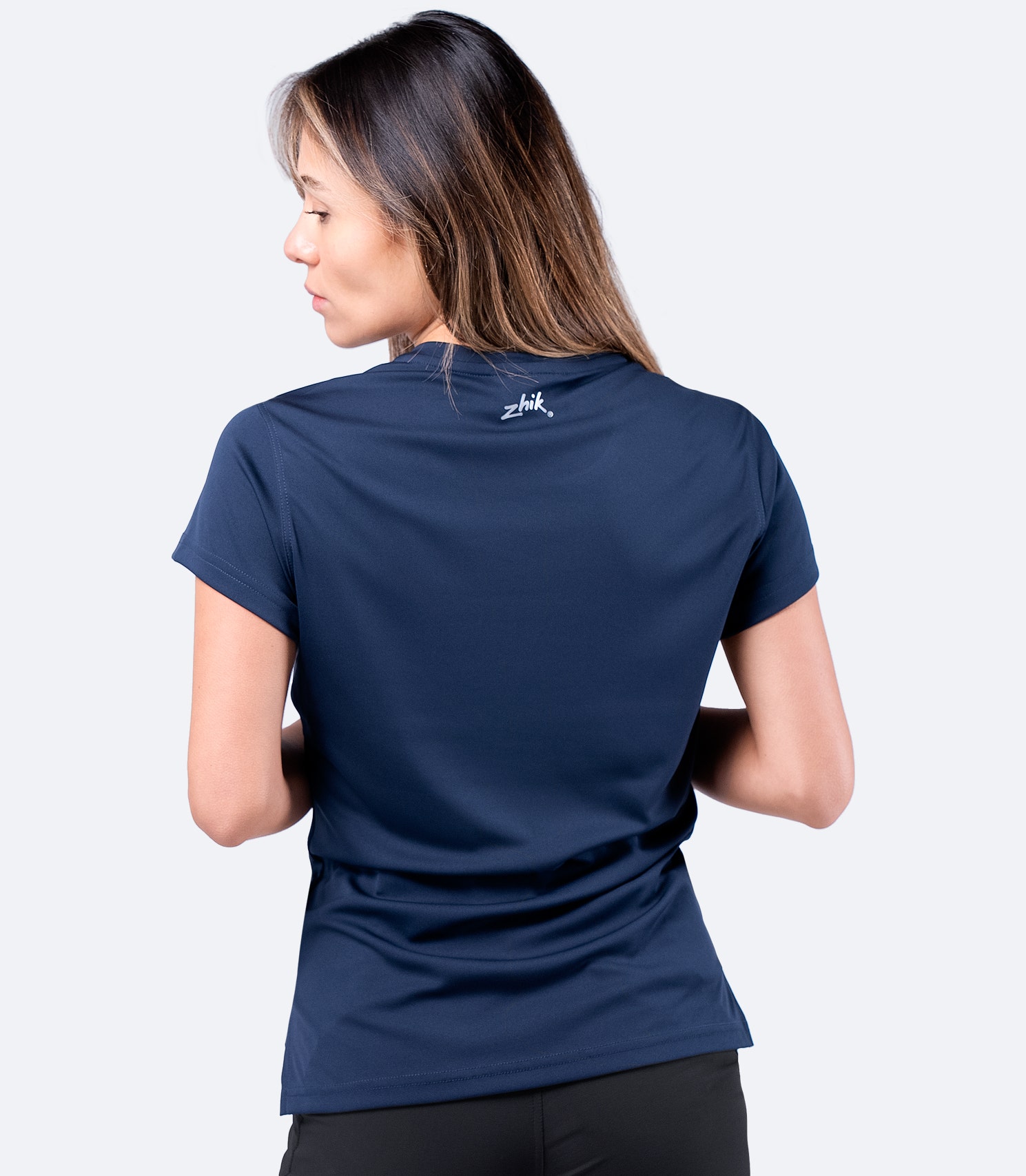 Back view of navy Zhik Women's UVActive Short Sleeve Top, showcasing performance fit and lightweight fabric.