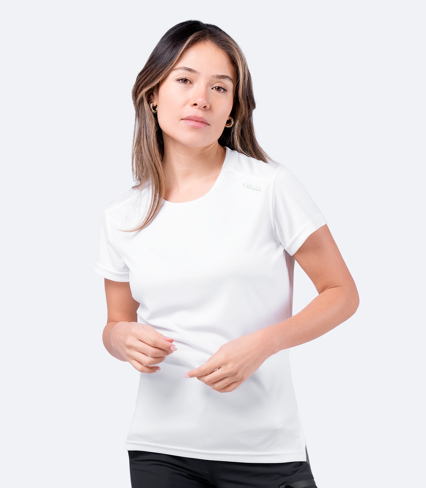 Model wearing Zhik Women's UVActive Short Sleeve Top in white, designed for maximum breathability and sun protection.
