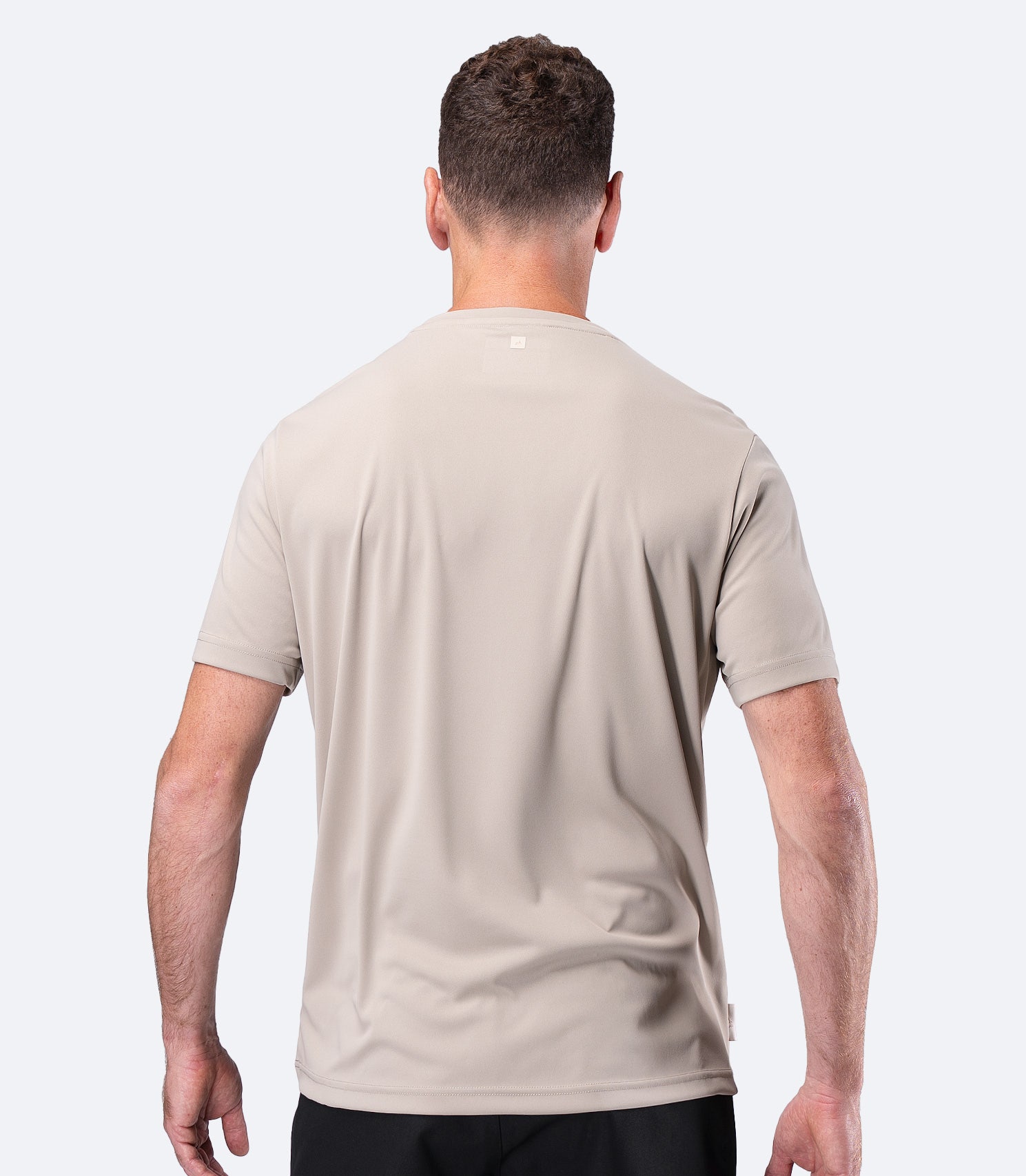 Rear view of Zhik Men's UVActive Short Sleeve Tech Tee in Stone with smooth snag-resistant back panel