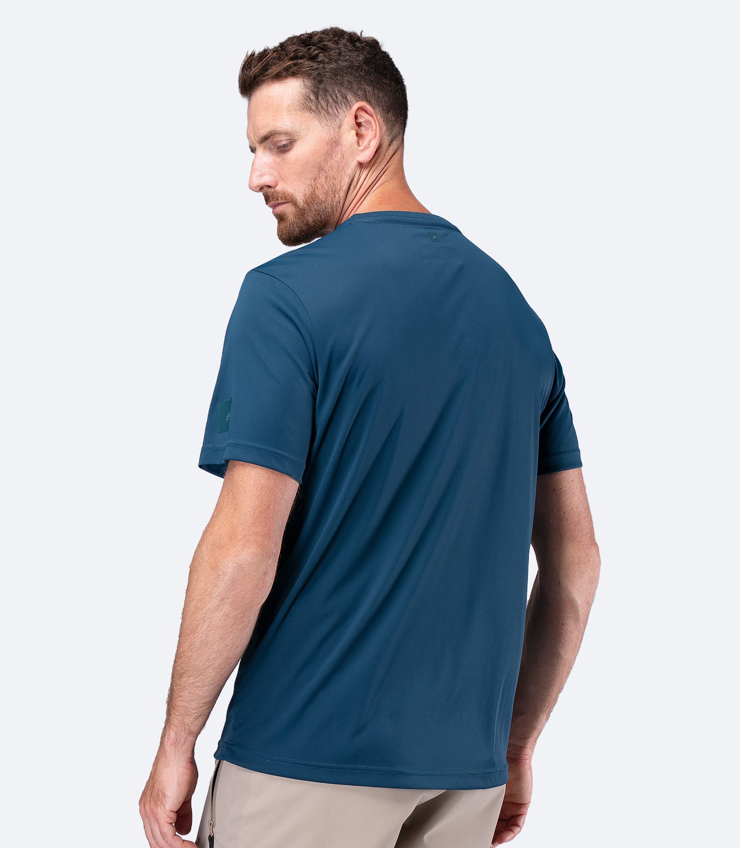 Rear view of Zhik Men's UVActive Short Sleeve Tech Tee in Deep Teal with smooth, durable back panel