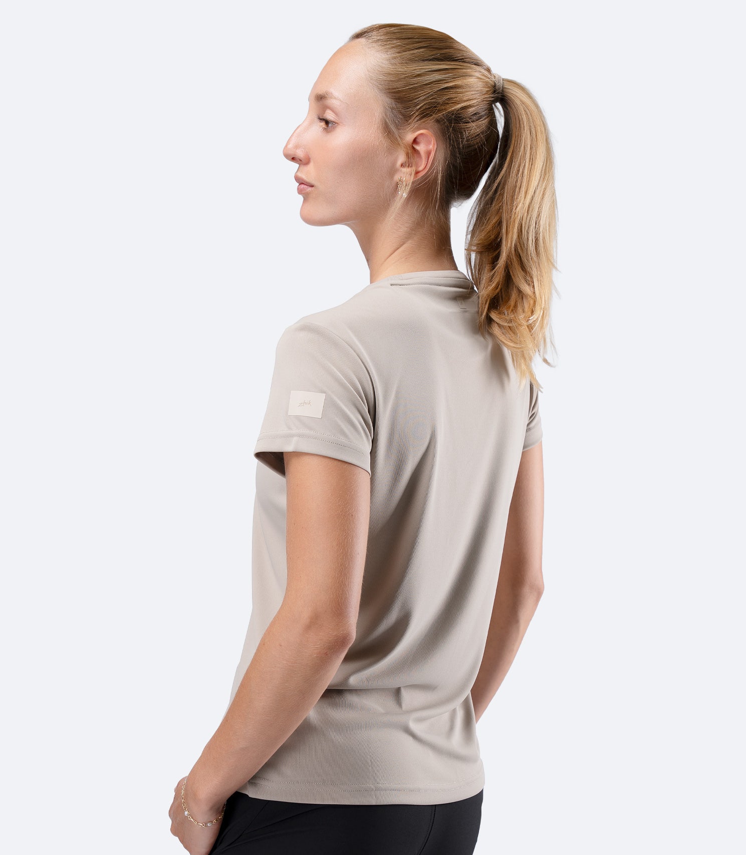 Zhik Women's UVActive short sleeve tech tee in Stone, clean side profile showing breathable regular fit for active use