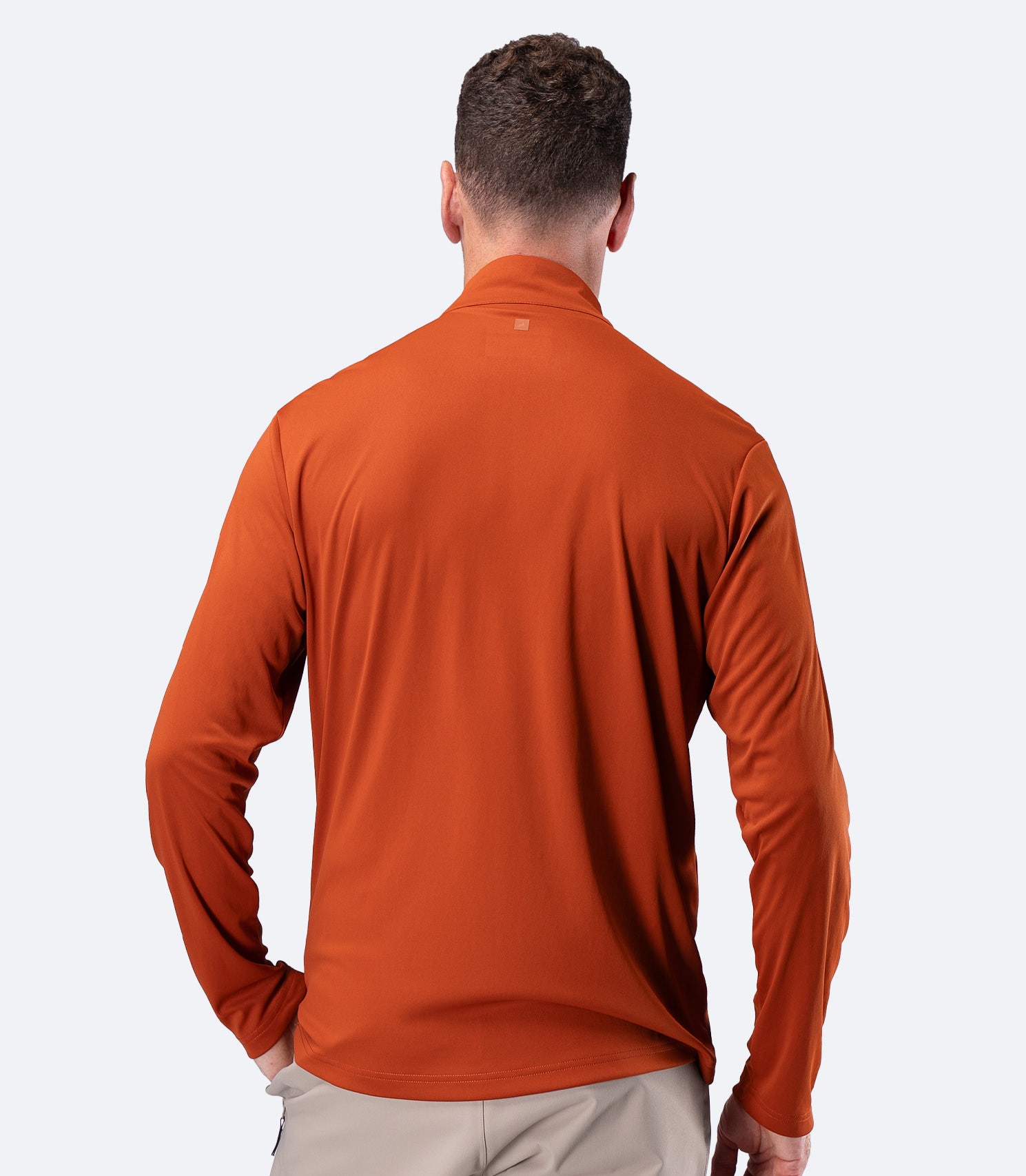 Rear view of Zhik Men's UVActive Long Sleeve Tech Top in Red Earth, showing full back sun coverage