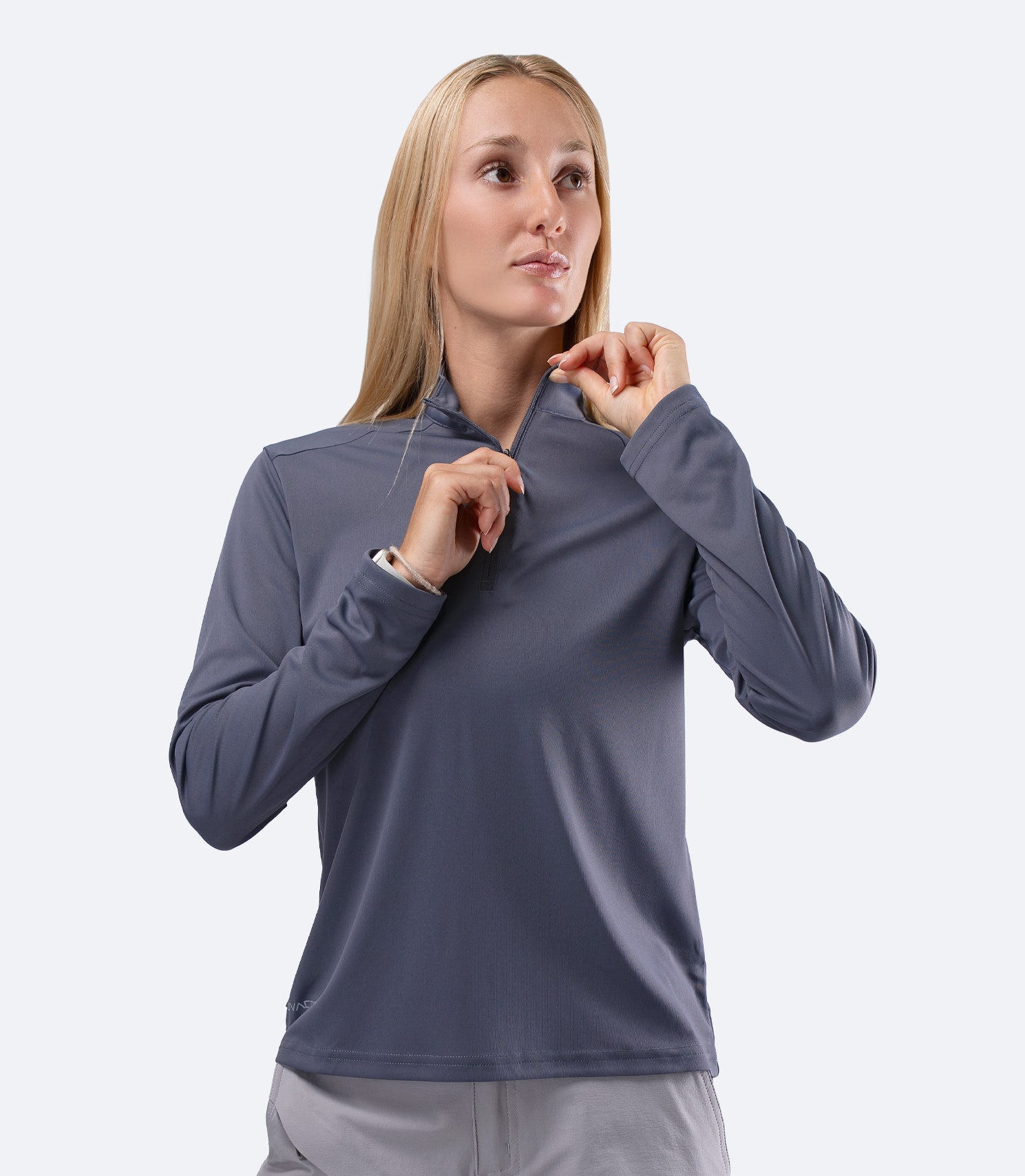 Front view of Slate Zhik Women's UVActive 1/4 Zip Top, hand on zip for venting and thermal control