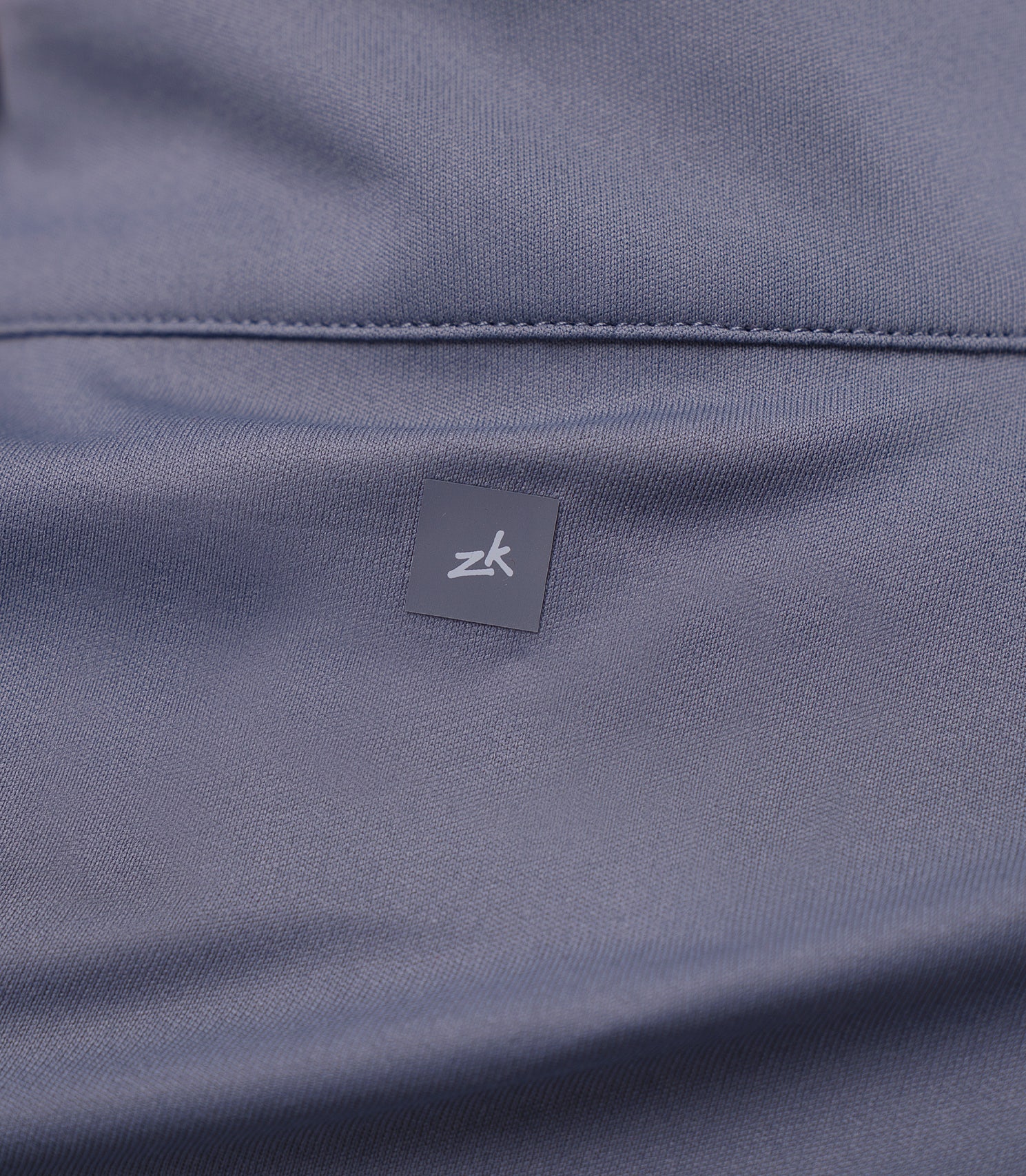 Back shoulder view of Slate Zhik Women's UVActive Top, showing subtle logo between shoulder blades