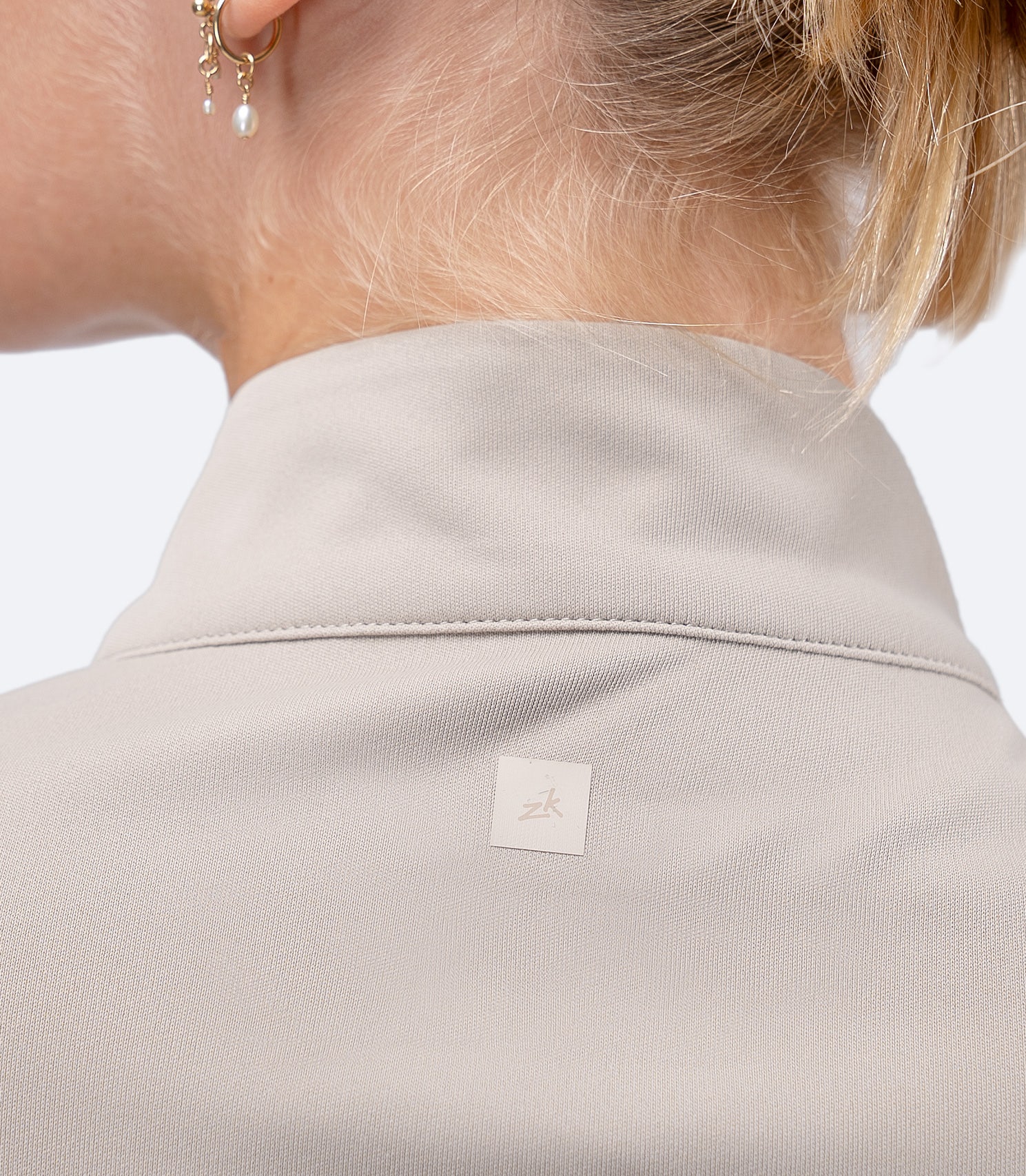 Back shoulder view of Stone Zhik Women's UVActive Top, showing subtle logo between shoulder blades