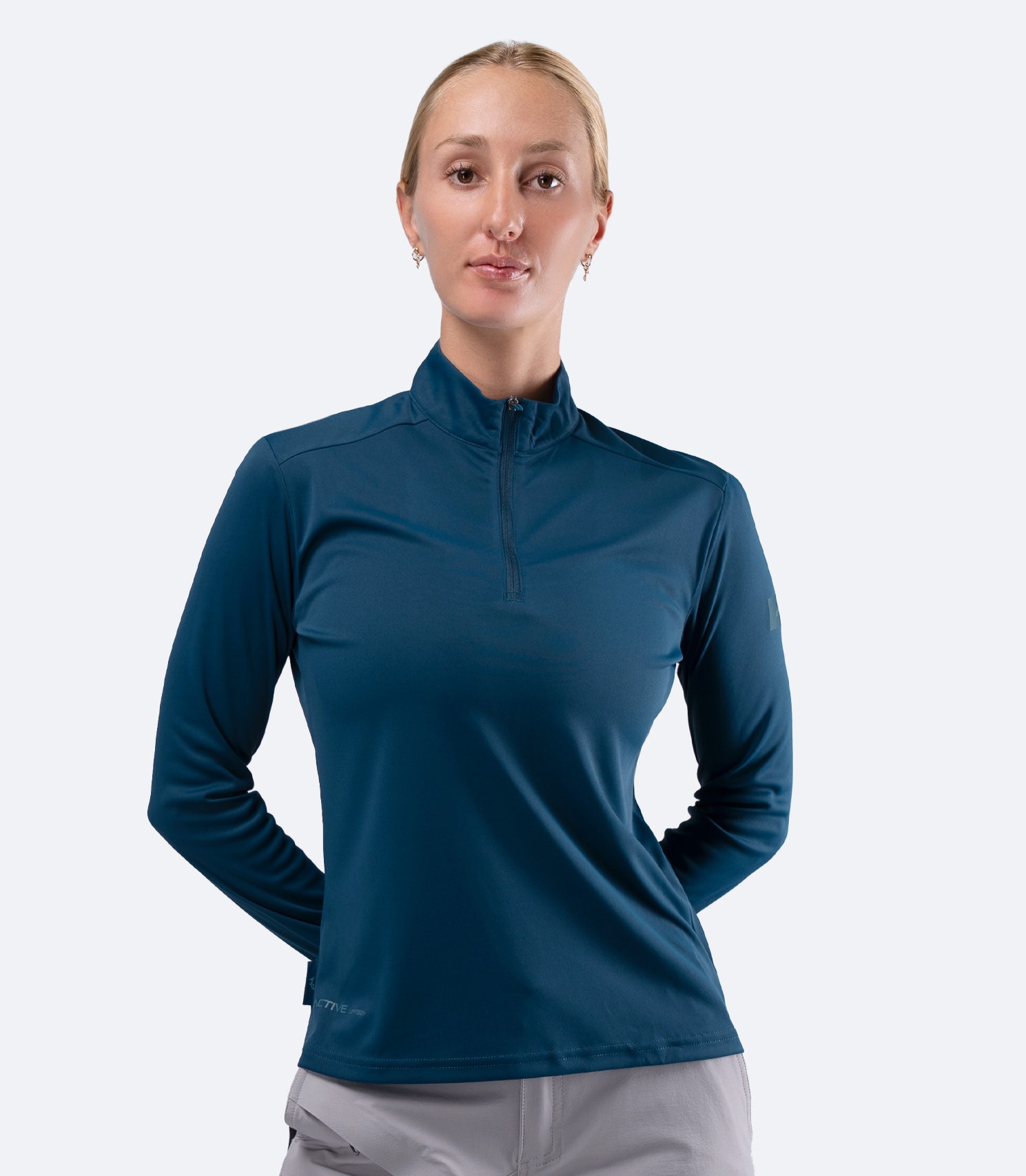 Front view of Zhik Women's UVActive 1/4 Zip Long Sleeve Tech Top in Deep Teal with long sleeve coverage
