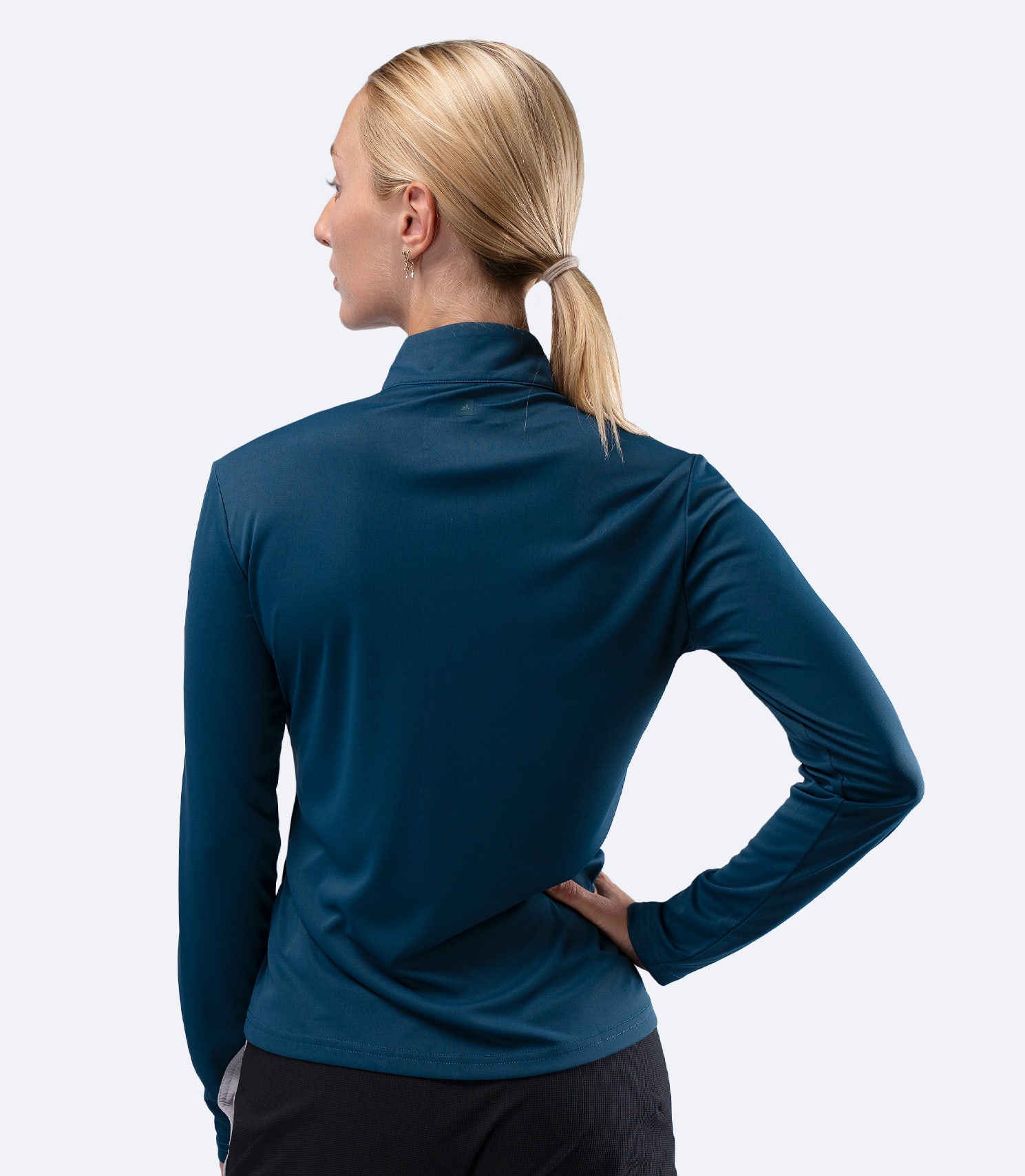 Rear view of Zhik Women's UVActive 1/4 Zip Tech Top in Deep Teal, showing clean back panel and fit