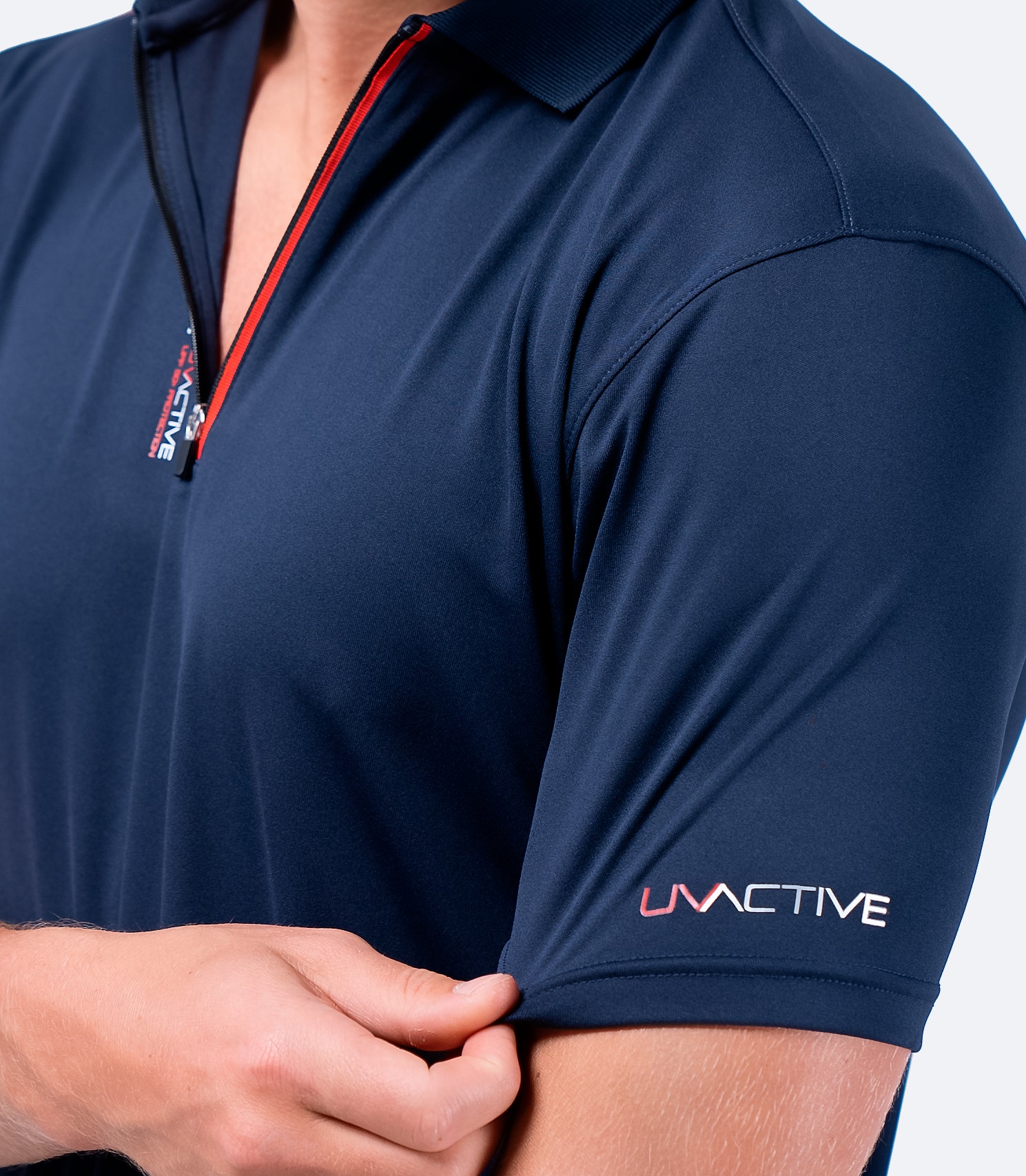 Close-up of navy Zhik Men's UVactive Zip Sports Polo sleeve, featuring performance-fit construction and snag-resistant material.