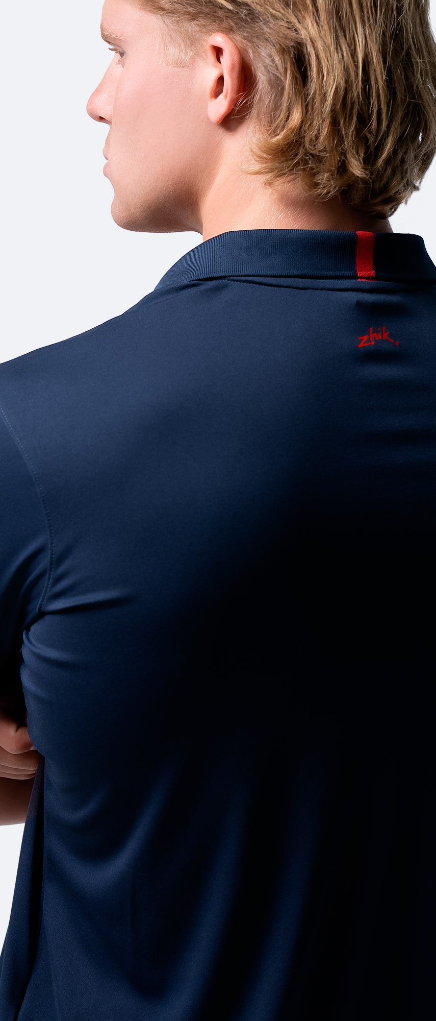Rear shoulder close-up of navy Zhik Men's UVactive Zip Sports Polo, showing lightweight fabric and seamless comfort.