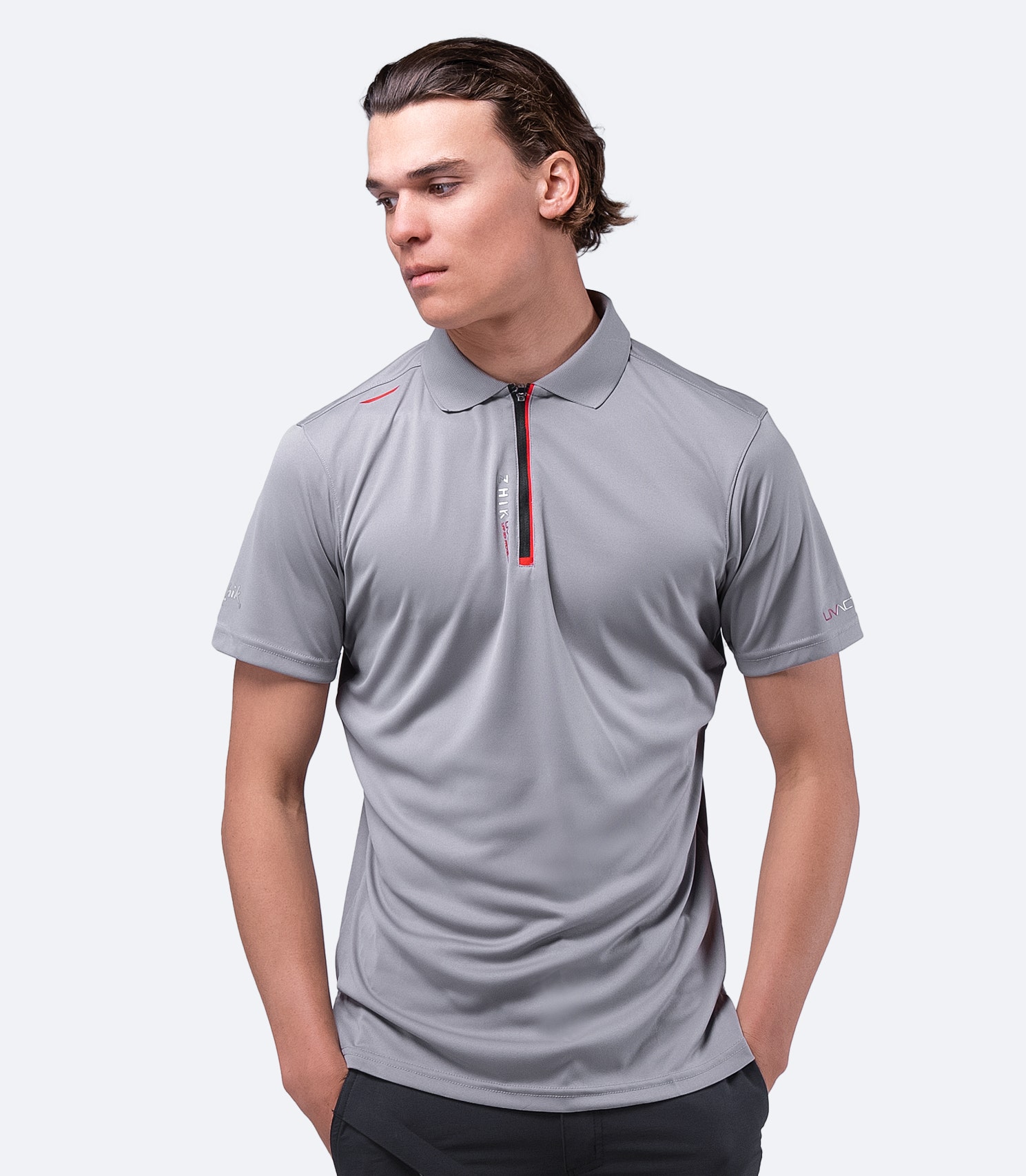 Model wearing grey Zhik Men's UVactive Zip Sports Polo with breathable, quick-drying fabric and ergonomic fit.