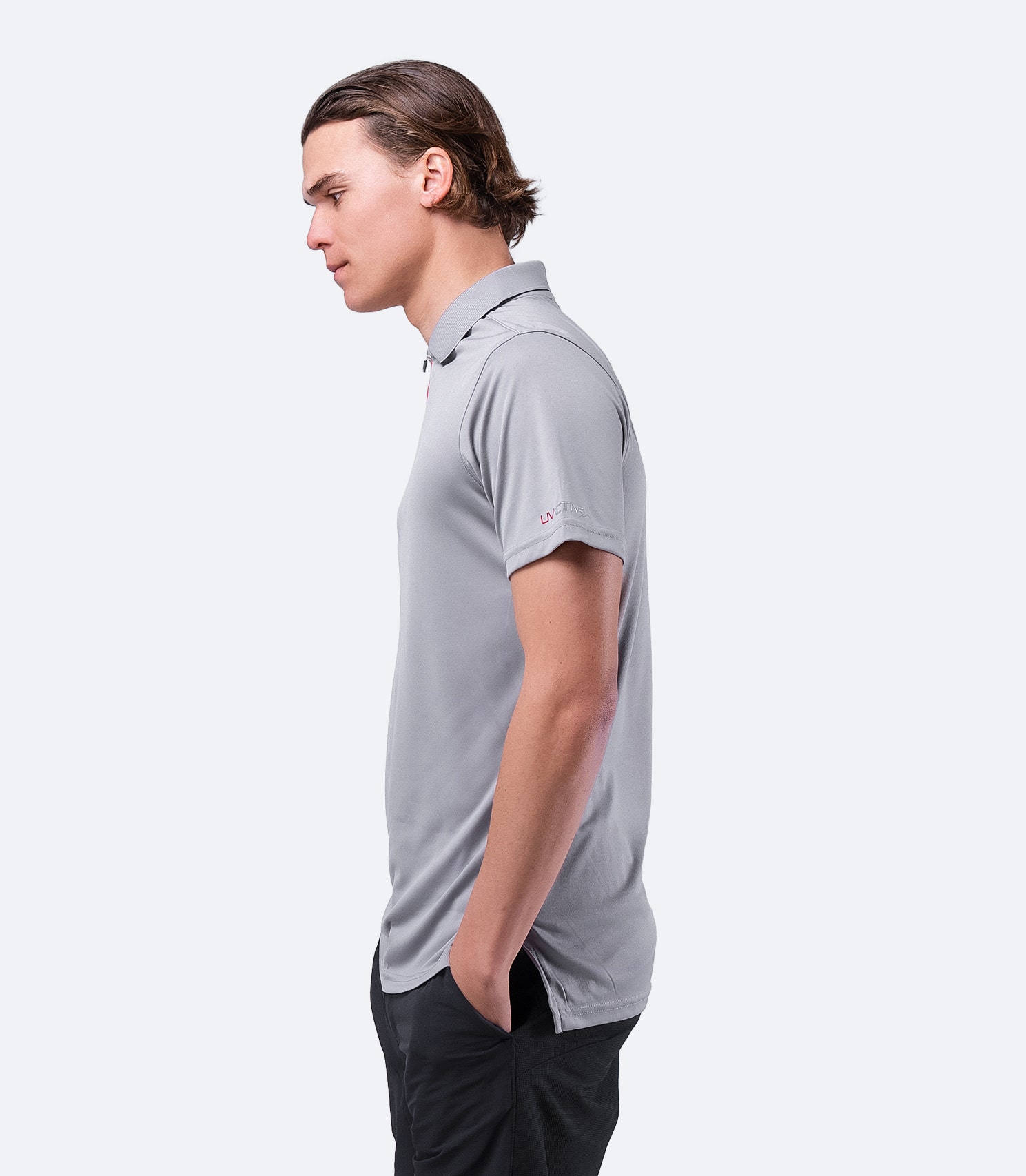 Side view of grey Zhik Men's UVactive Zip Sports Polo, showcasing performance fit with Velcro-resistant, durable fabric.