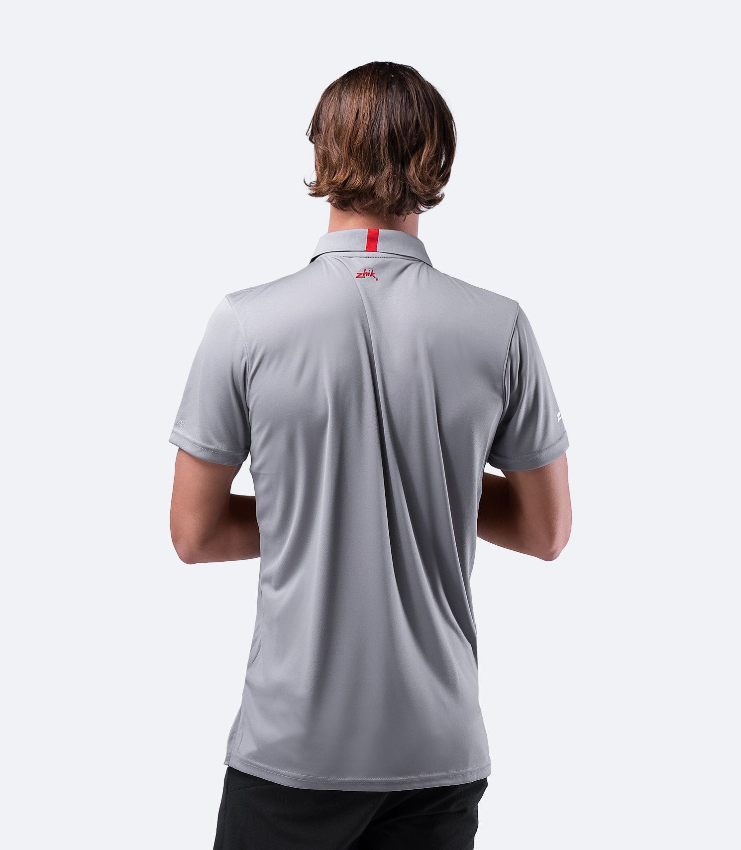 Rear shoulder close-up of grey Zhik Men's UVactive Zip Sports Polo, highlighting seamless construction and breathable fabric.