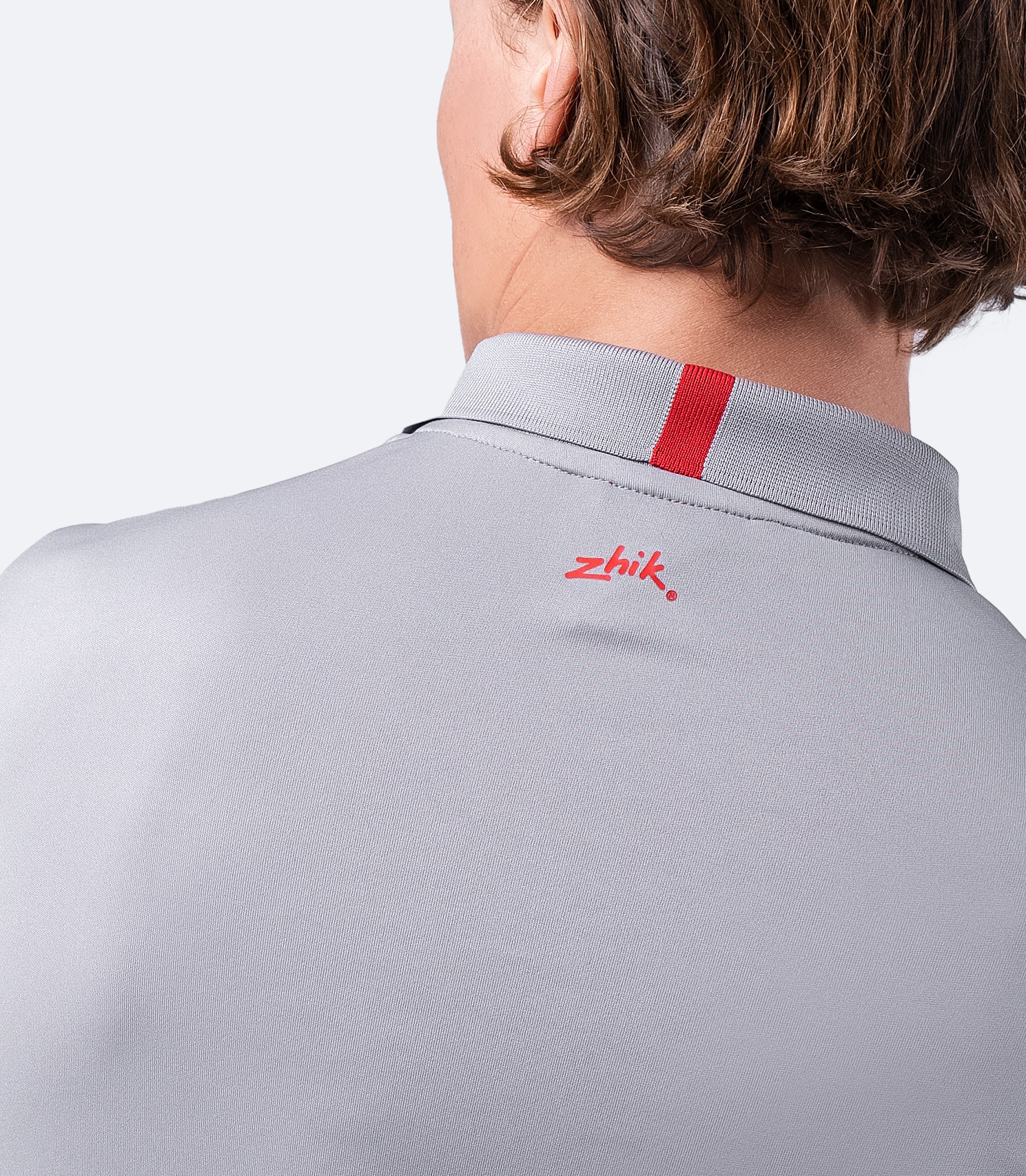 Rear shoulder close-up of grey Zhik Men's UVactive Zip Sports Polo, highlighting seamless construction and breathable fabric.