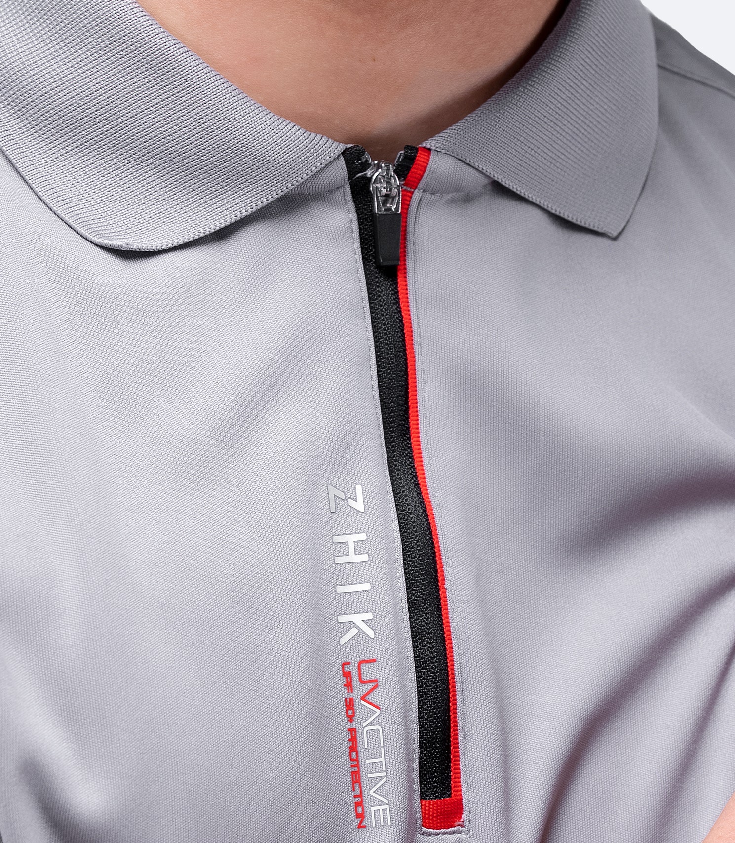 Close-up of grey Zhik Men's UVactive Zip Sports Polo, featuring soft, high-gauge polyester fabric and smooth collar design.