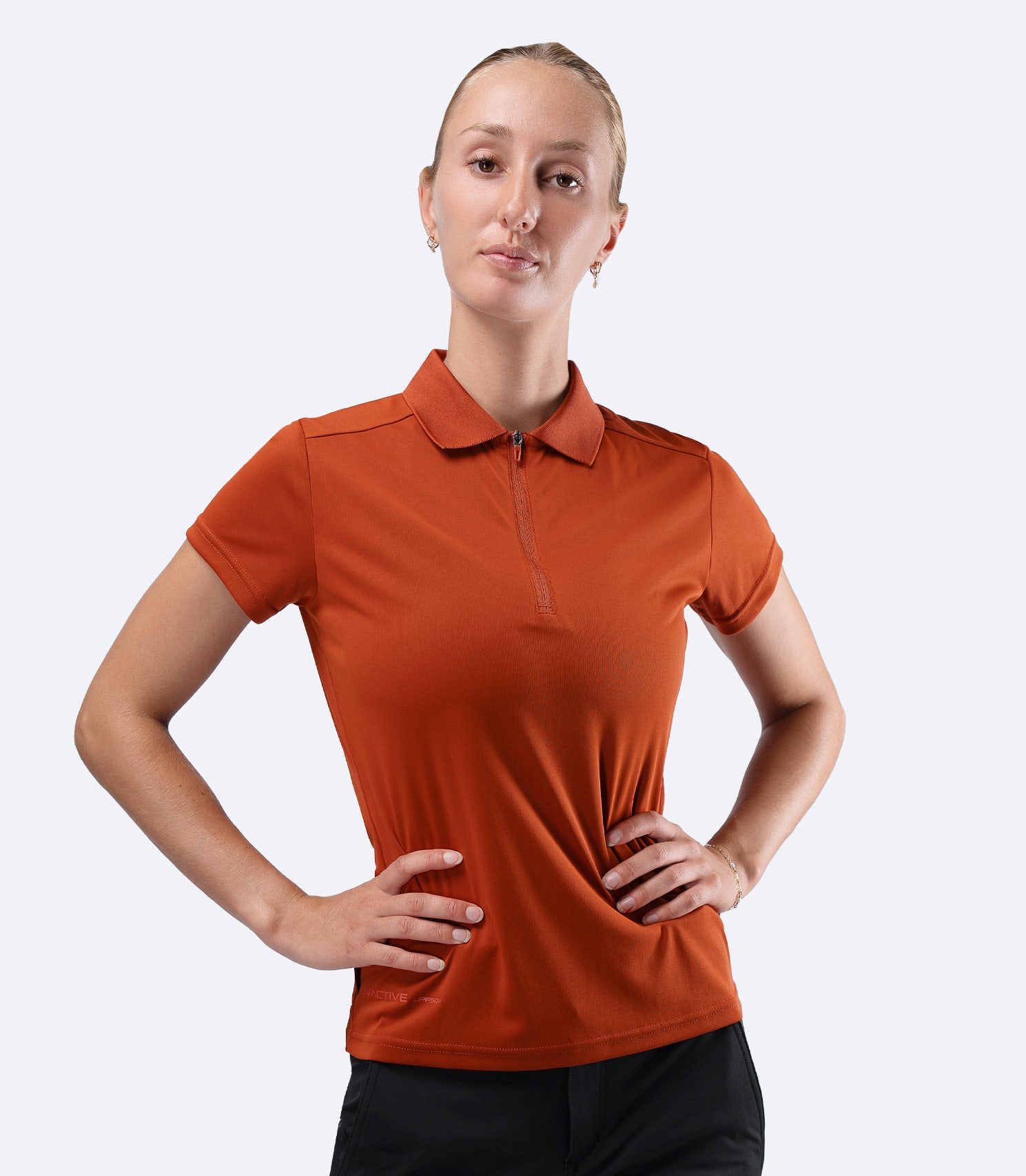Front view of Zhik Women's UVActive Short Sleeve Polo in Red Earth, showing classic sports styling
