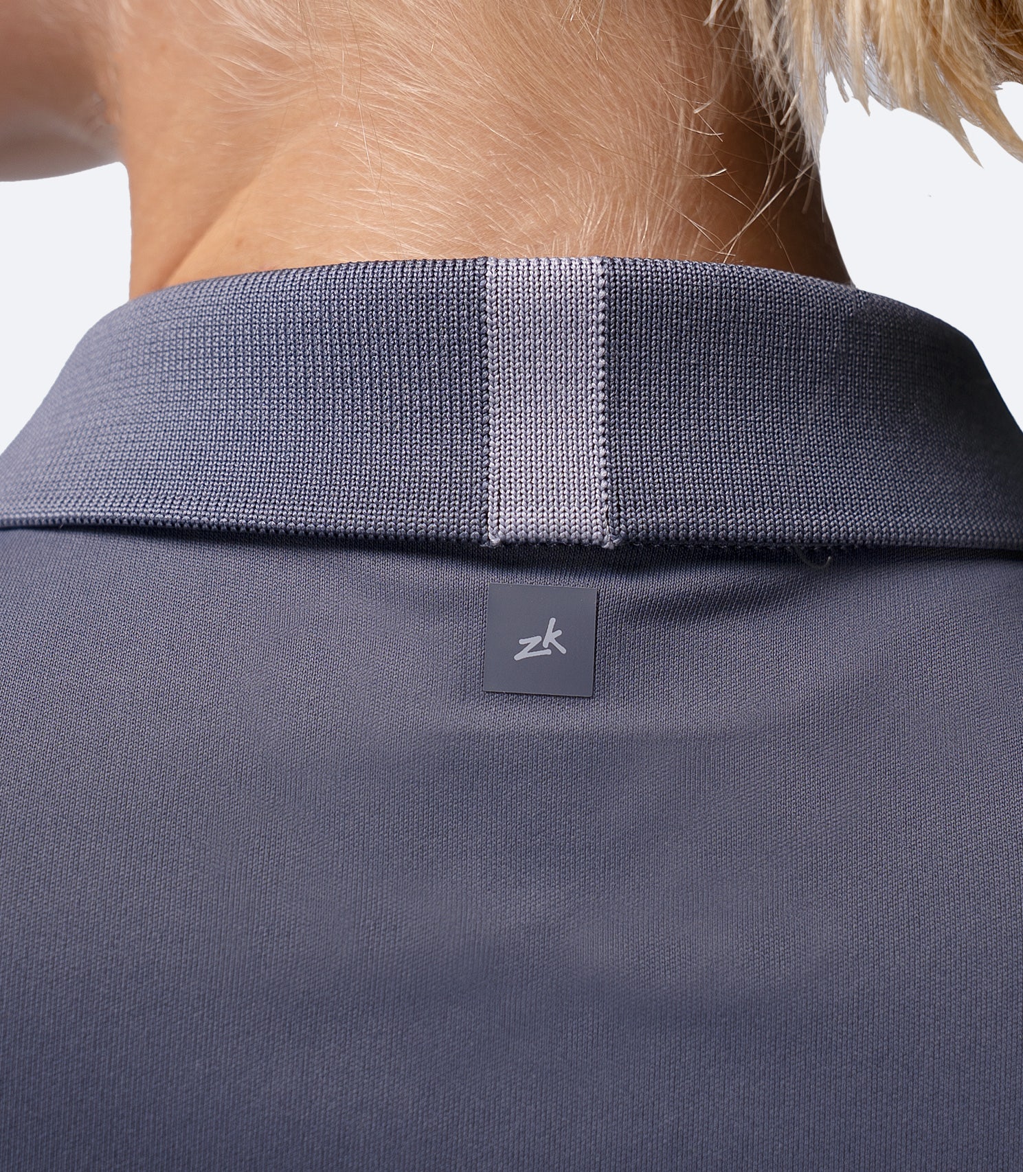 Close-up of shoulder blades on Zhik UVActive Polo in Slate, subtle back logo and smooth high-gauge knit