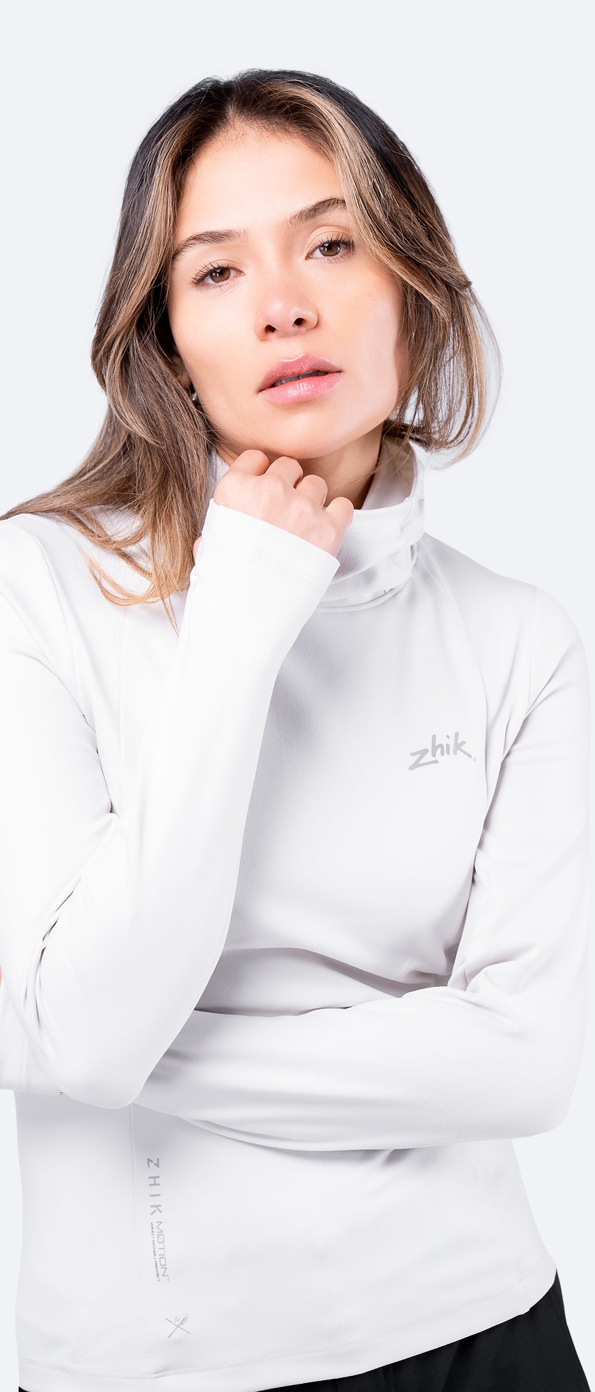Close-up of White ZhikMotion™ Hooded Top showing collar, soft peached fabric, and breathable knit for comfort in changing conditions.