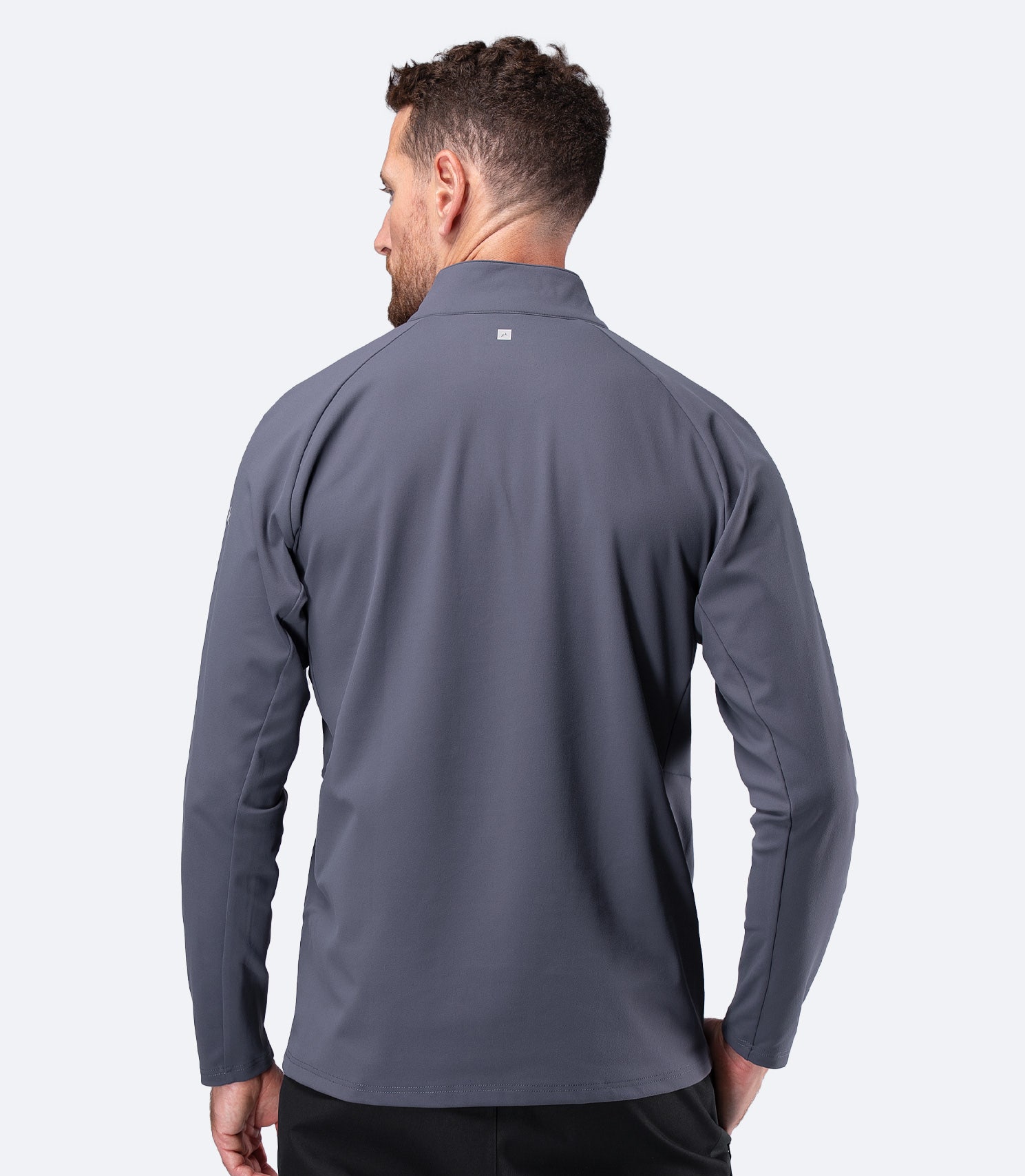 Rear view of Zhik Men's ZhikMotion 1/4 Zip Long Sleeve Top in Slate, showing streamlined back panel