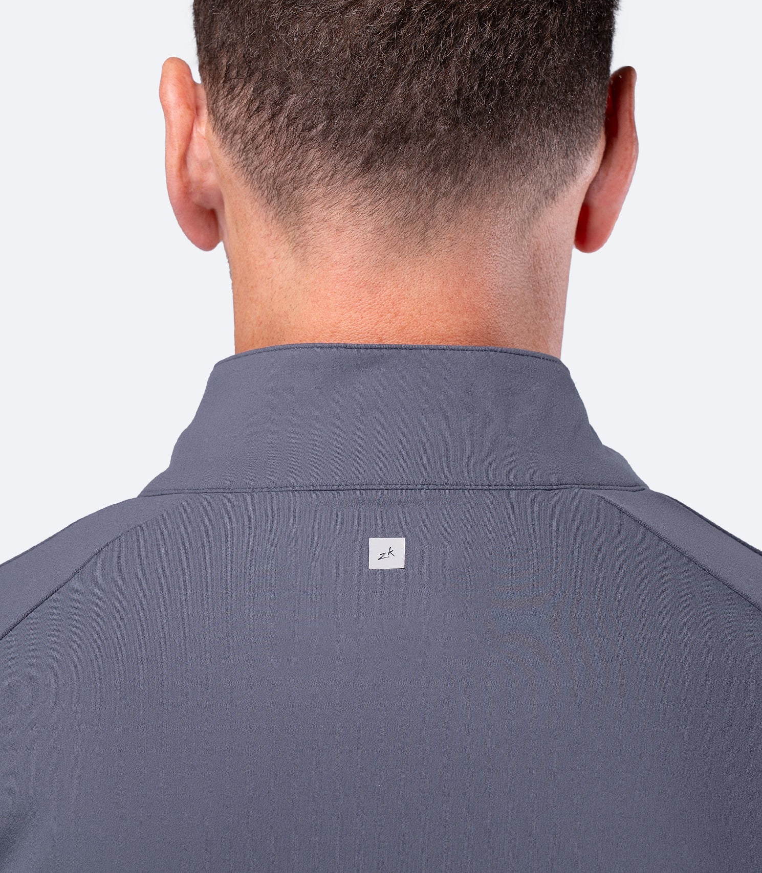 Rear shoulder blade close up of Zhik Men's ZhikMotion Top in Slate, featuring subtle back Zhik logo