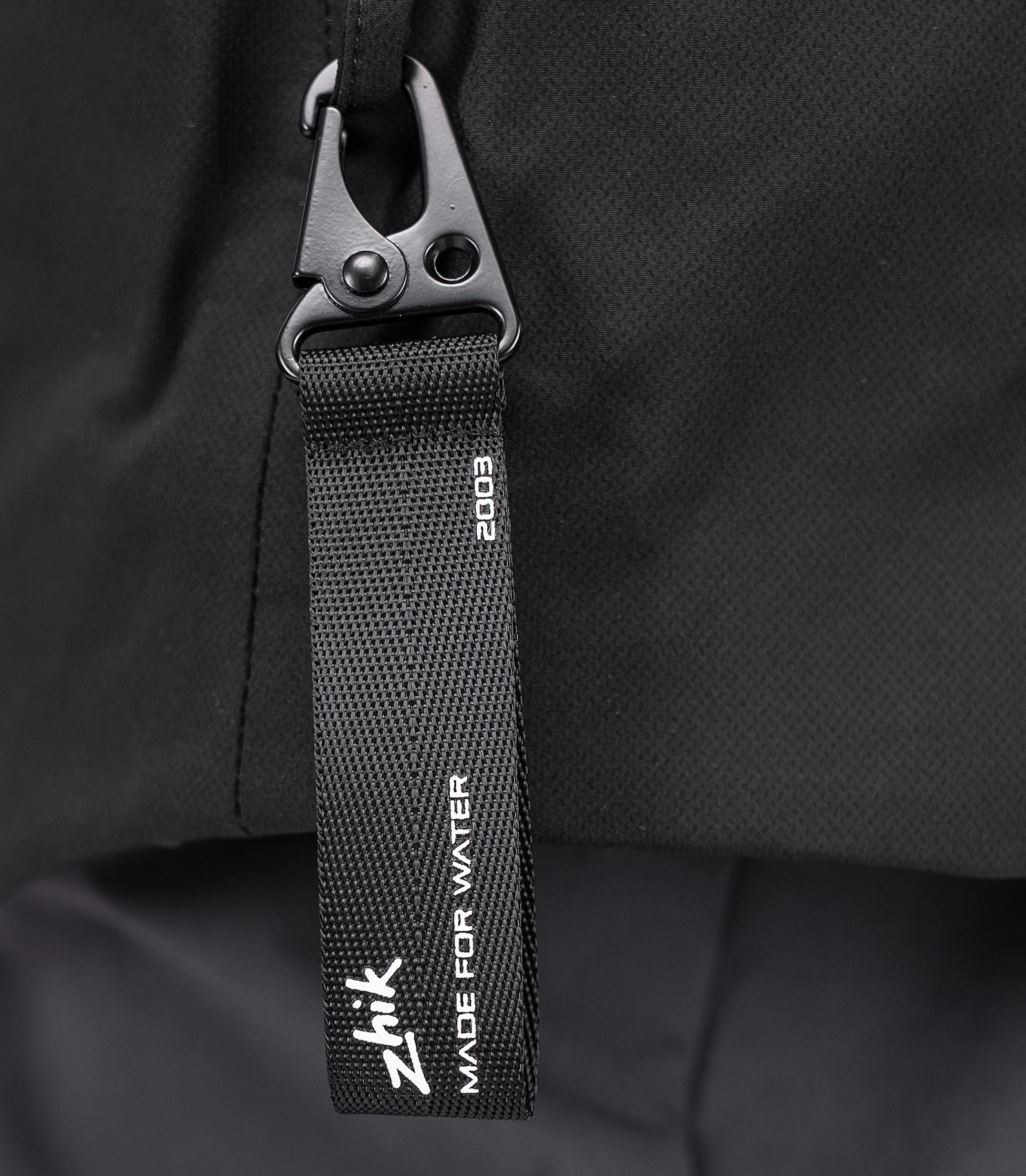 Close-up of Zhik All Weather Coat's side hook for attaching keys, knives, or boat kill cord.