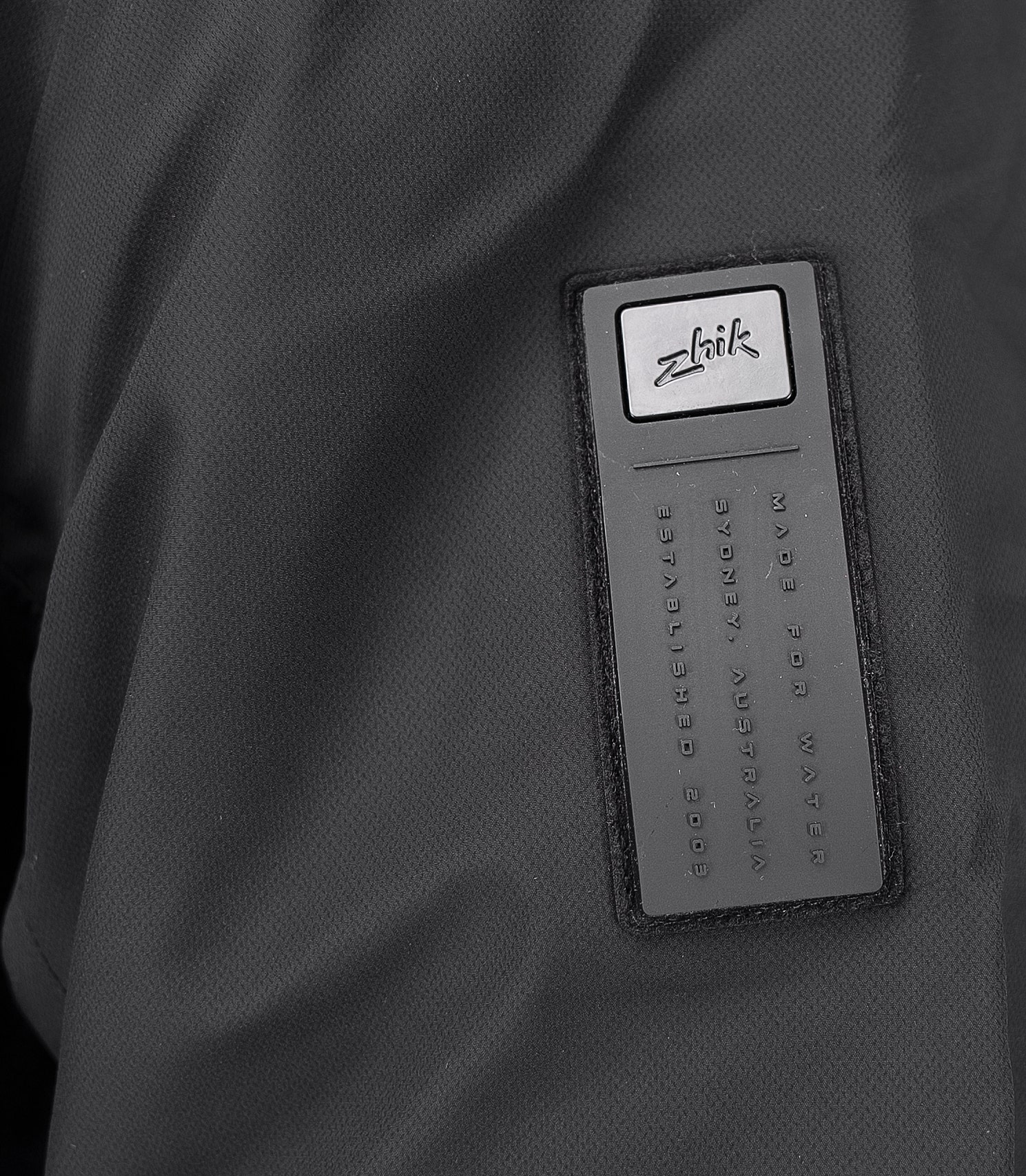 Close-up of the Zhik logo on the All Weather Coat, showcasing the brand’s signature performance-driven design.