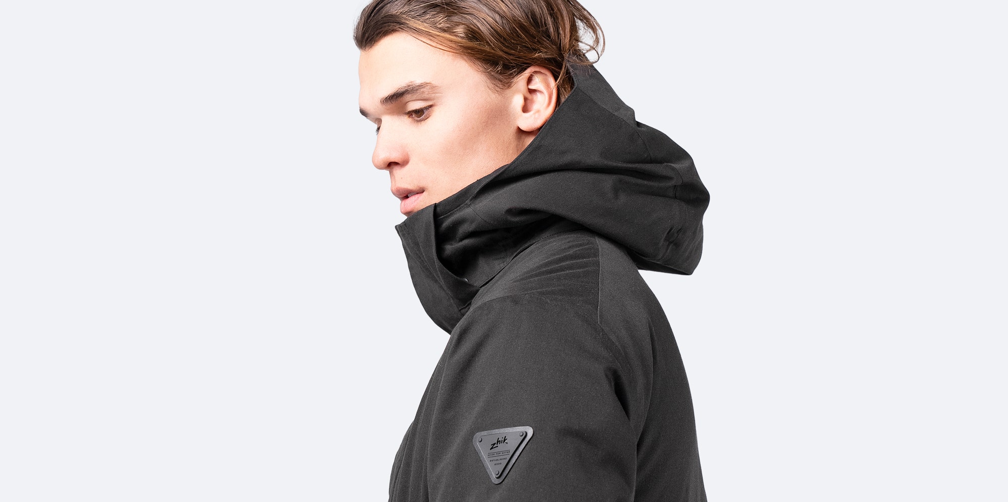 Zhik Broadside Coat in black, a waterproof medium-length coat with mid-height collar and insulated warmth.