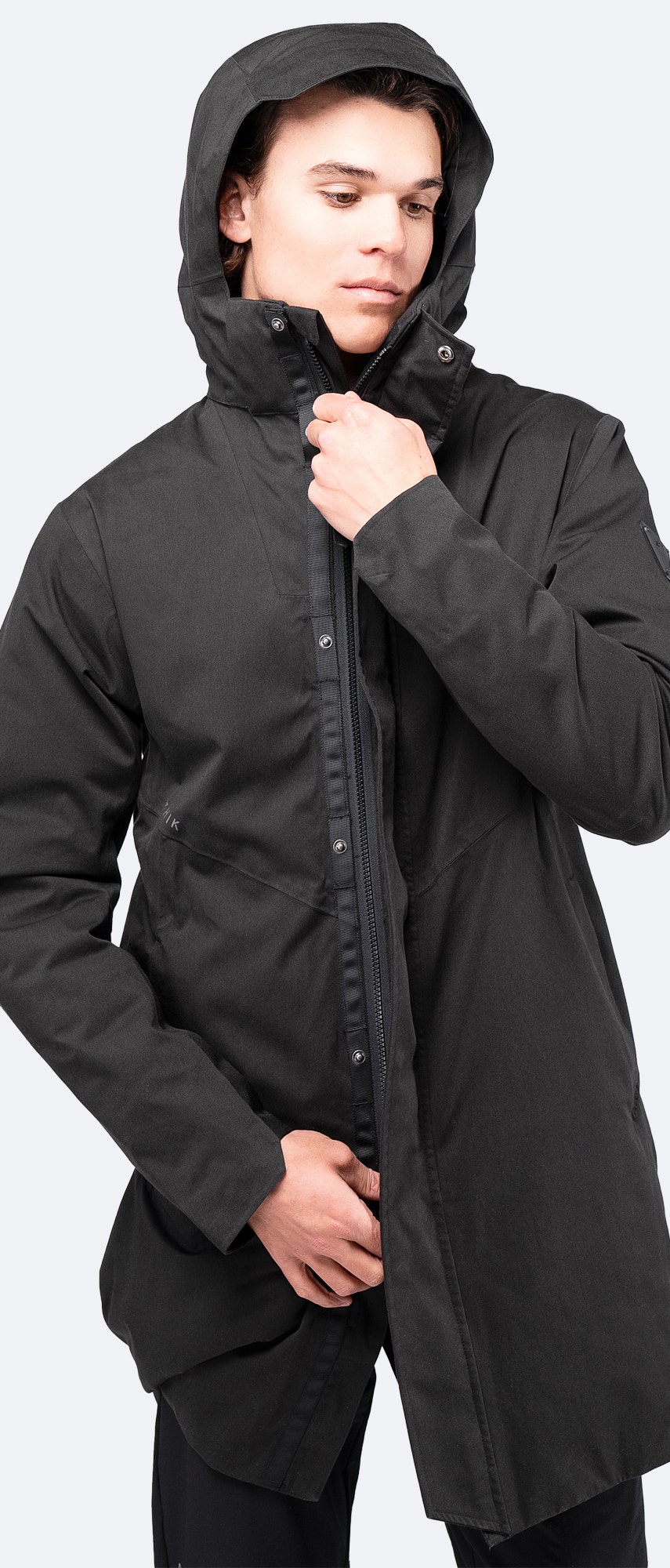Front view of Zhik Broadside Coat in black with closed zipper, mid-height collar, and oversized removable hood.