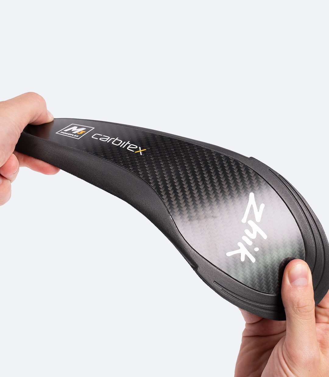 Bottom view of black Zhik Hiking X Carbon Insole, highlighting carbon fibre structure for stiffness and support