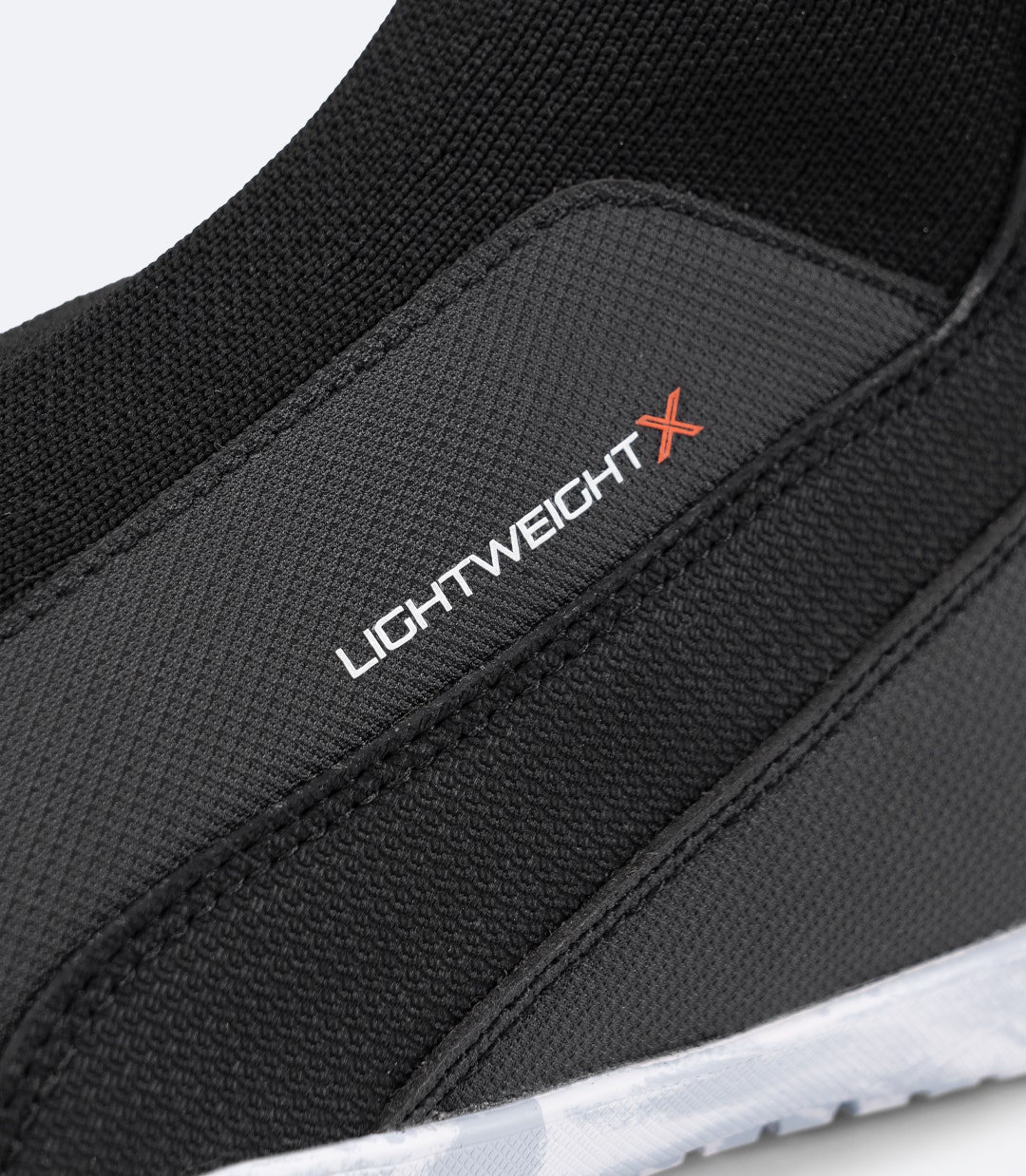 Close-up of Lightweight X label on Black Zhik High Cut X Boot, on ribbed 3D knitted upper