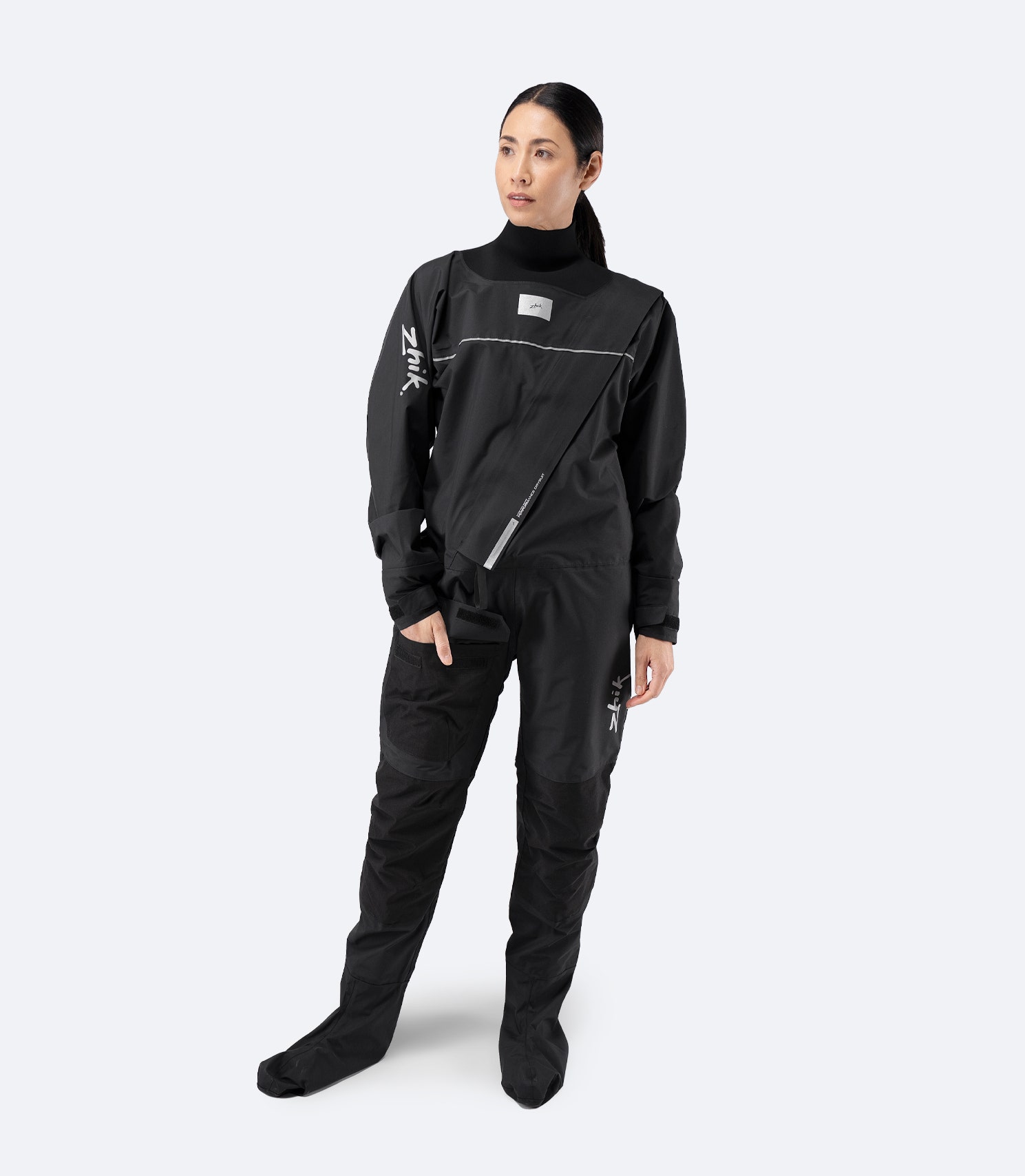 Female model wearing Zhik Adult Performance Drysuit in black, front view