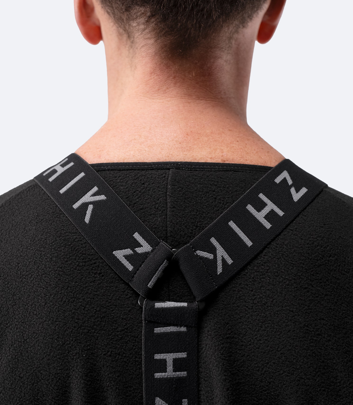 Close-up of branded suspenders inside Zhik Adult Performance Drysuit