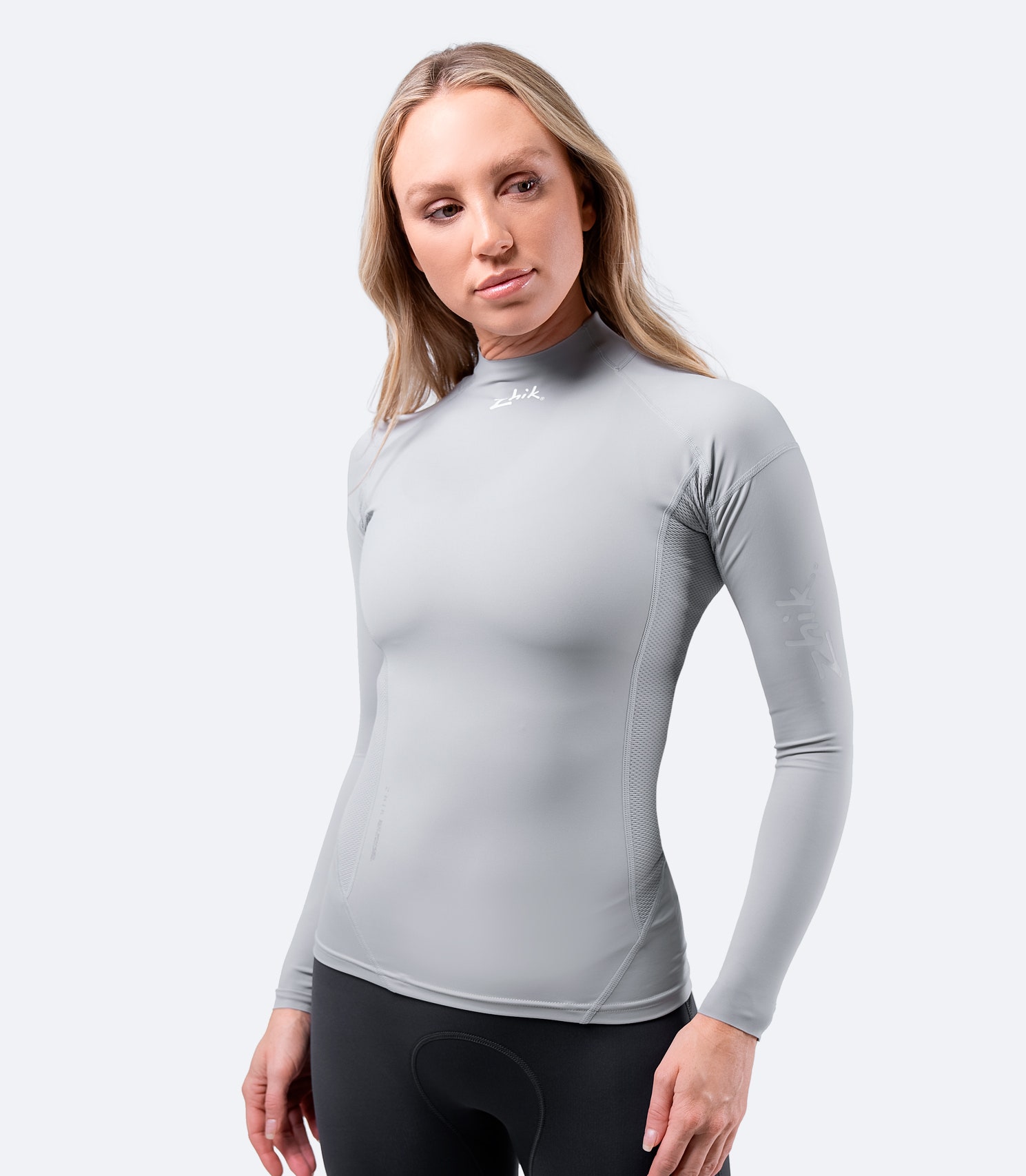 Front view of Zhik Women's Platinum Eco Spandex Long Sleeve Top with 240GSM recycled nylon fabric and perforated side panels for breathability.