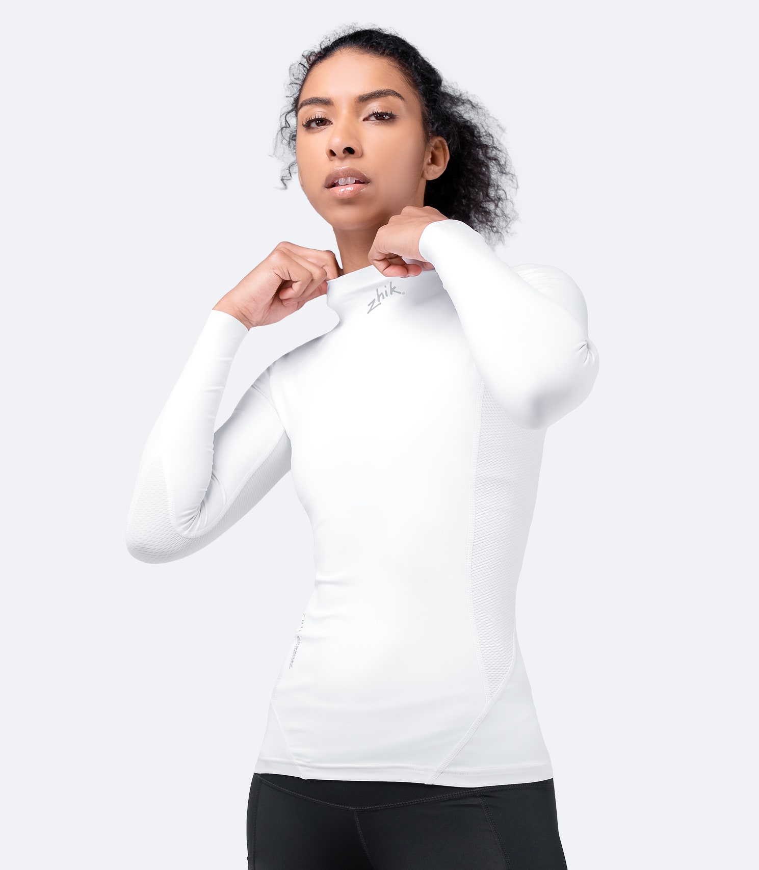 Front view of Zhik Women's White Eco Spandex Long Sleeve Top with breathable perforated panels and flexible, high-stretch fabric.