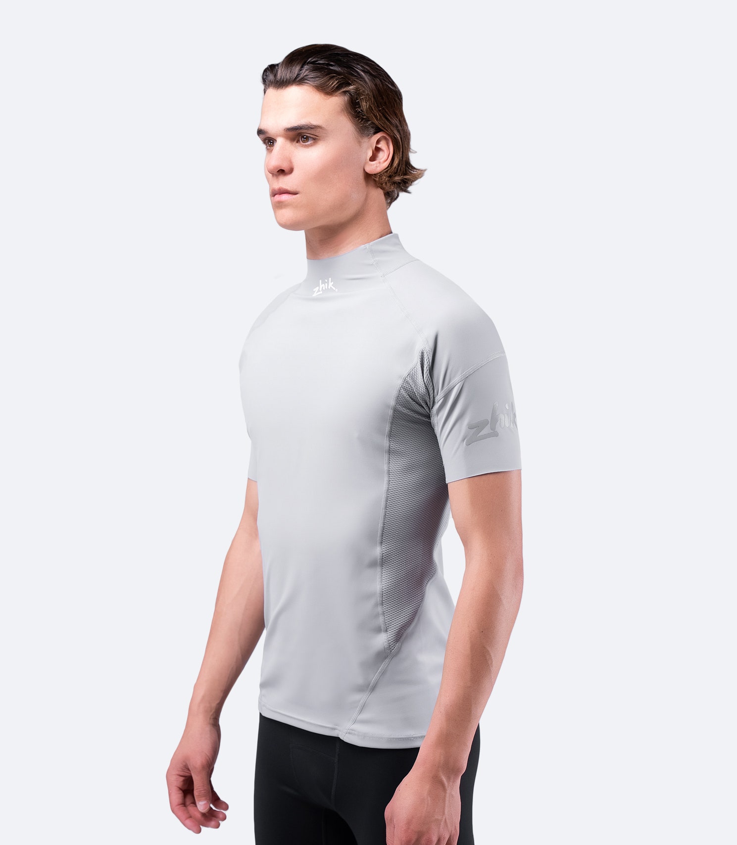 Side view of Platinum Eco Spandex Top with visible Zhik logo, featuring breathable fabric and ergonomic body panelling.