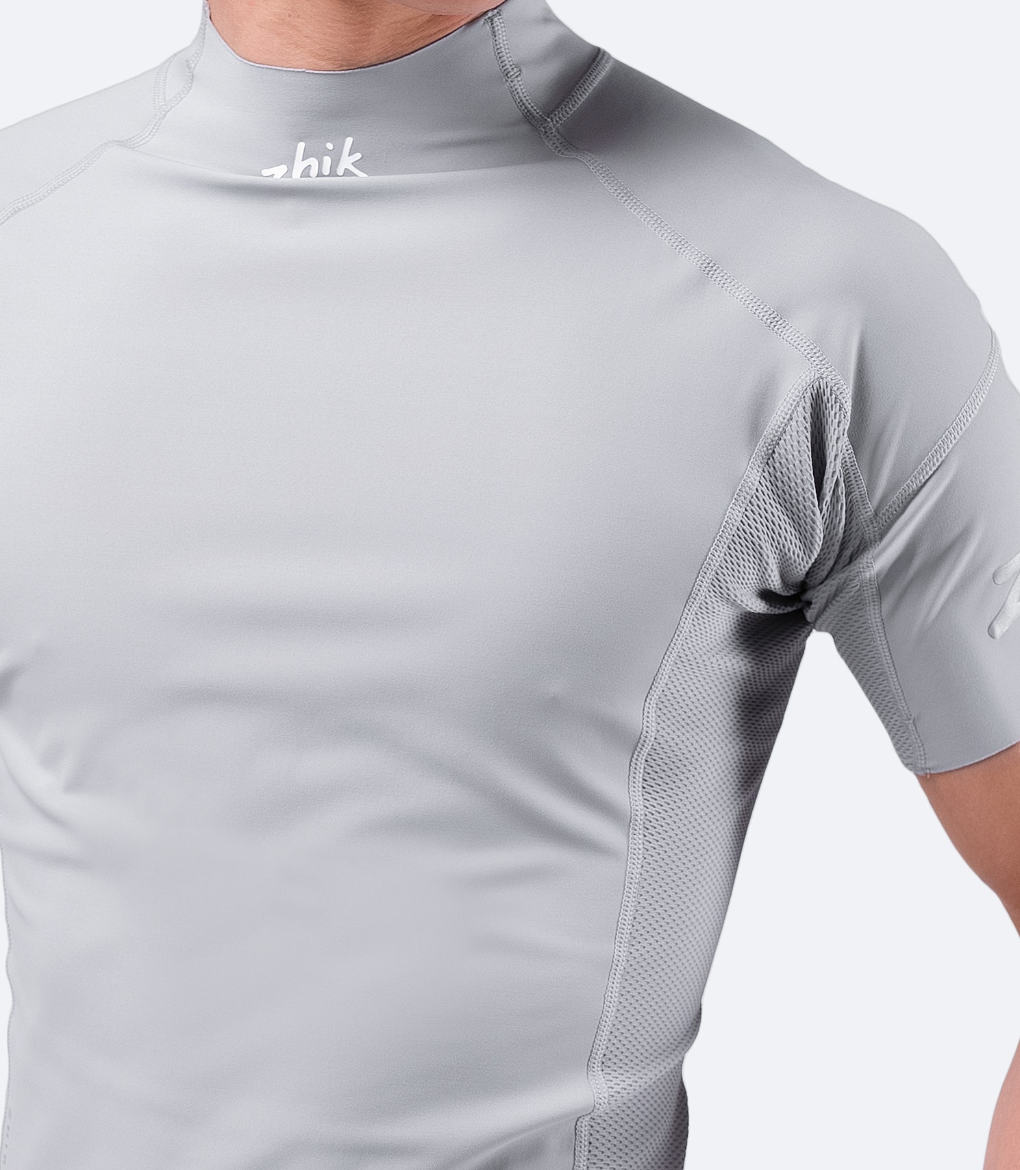 Close-up of Platinum Eco Spandex fabric near collar, highlighting soft cooling touch and perforated panels for ventilation.