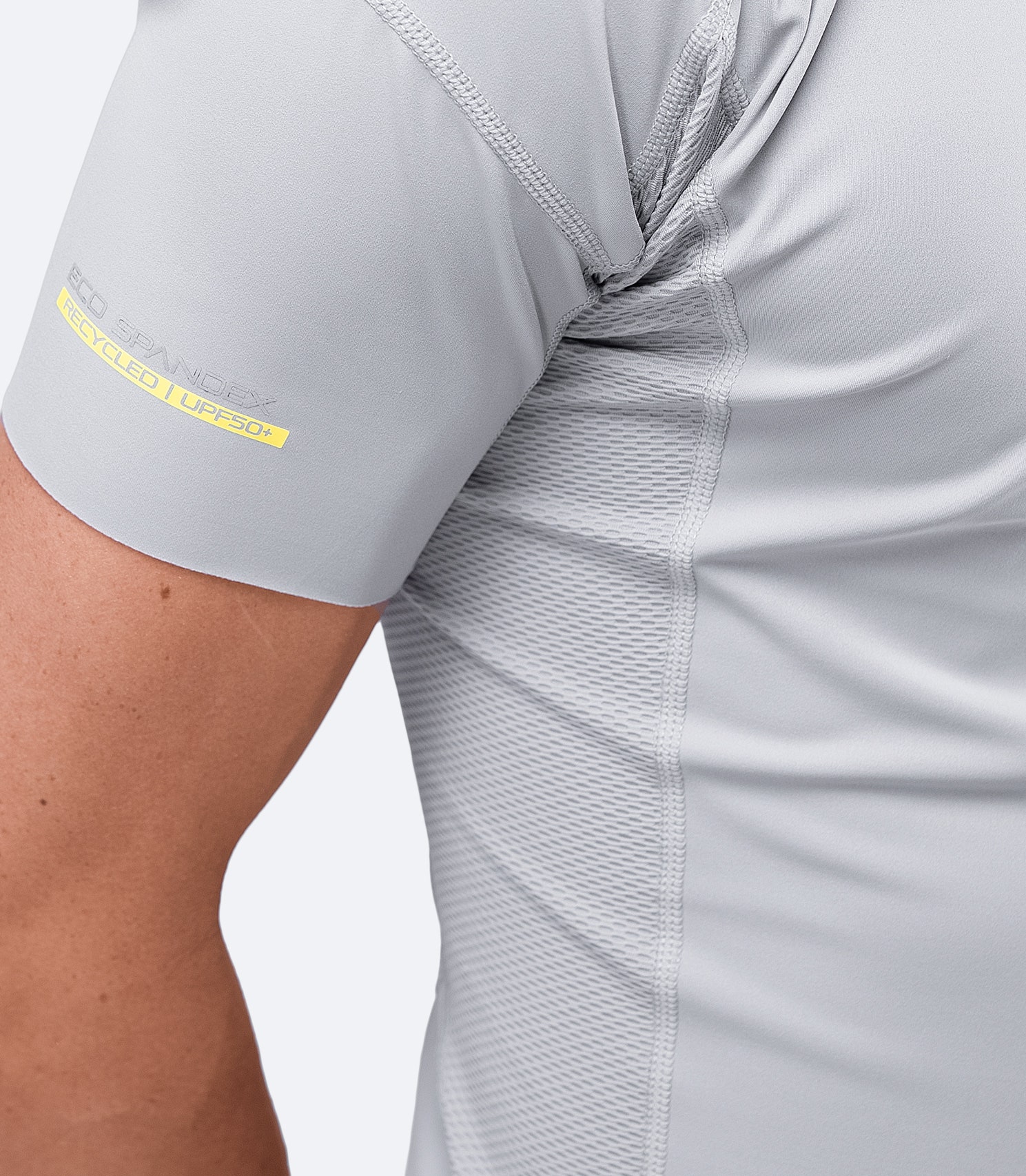 Close-up of Platinum Eco Spandex Top sleeves, highlighting anti-rash flatlock stitching and high-stretch recycled fabric.