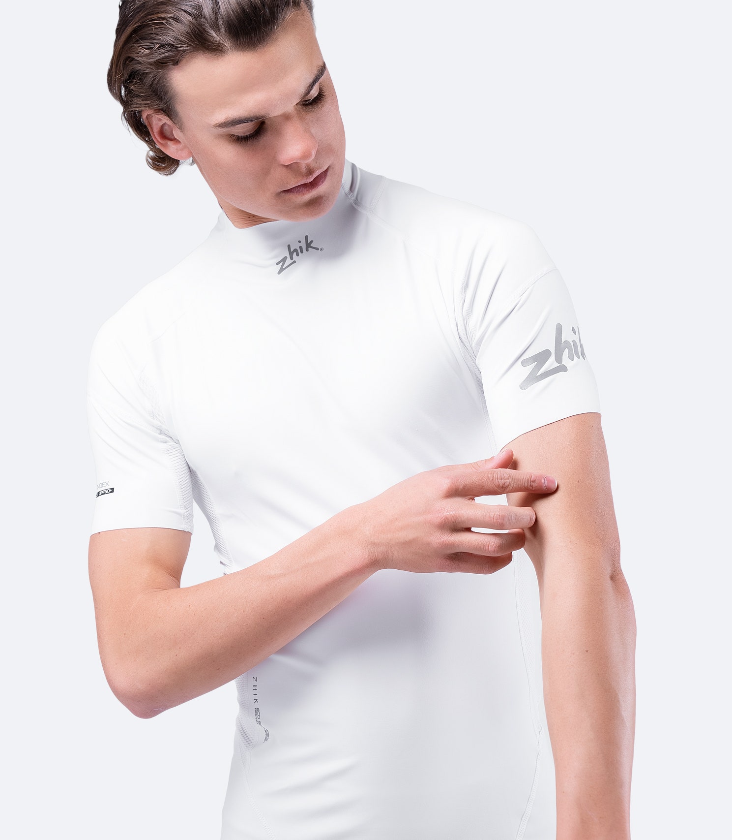 Side view of White Eco Spandex Top with Zhik logo, designed with recycled performance fabric and enhanced ventilation.