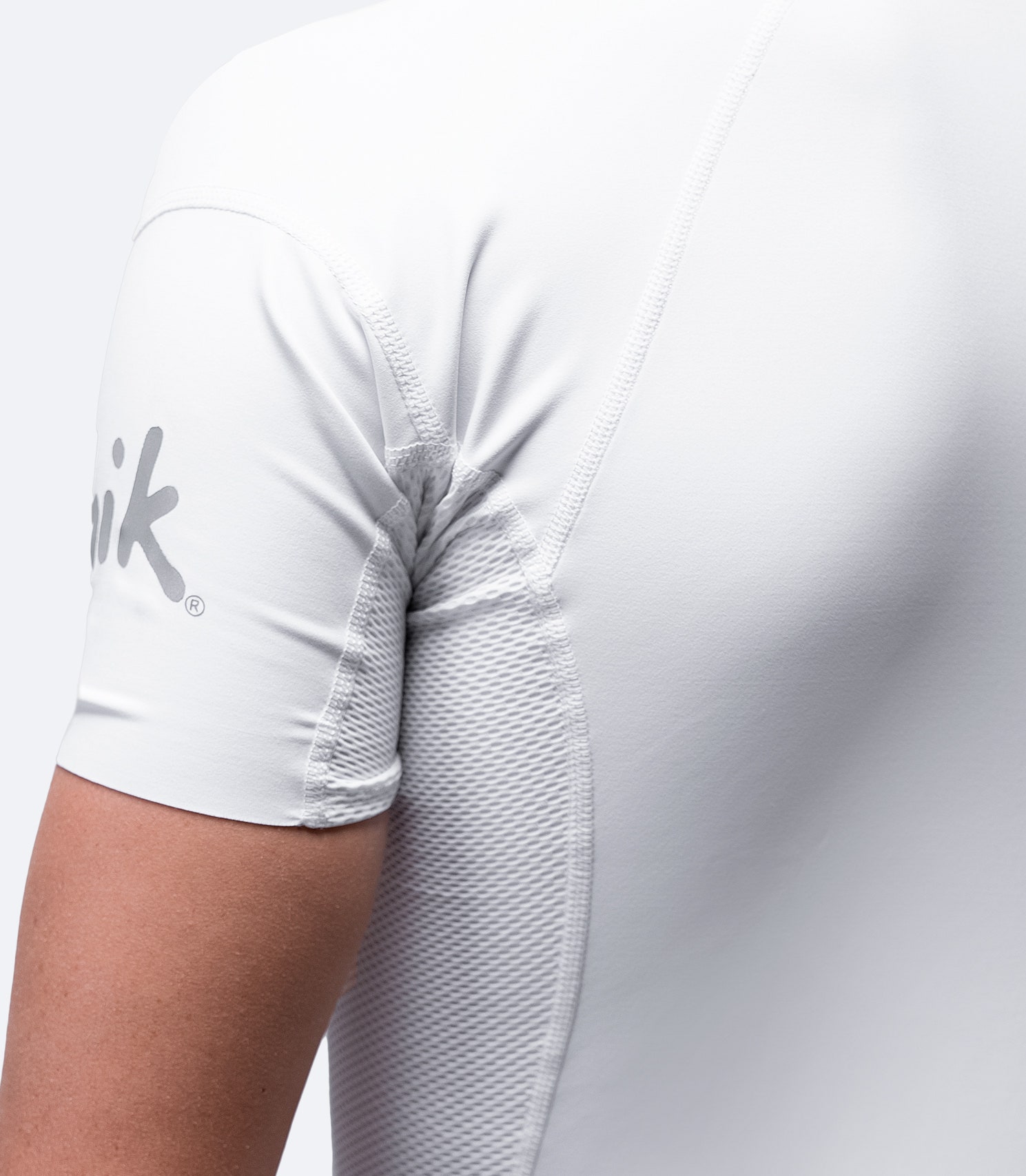 Close-up of White Eco Spandex Top sleeves, highlighting high-stretch flatlock stitching for comfort and durability