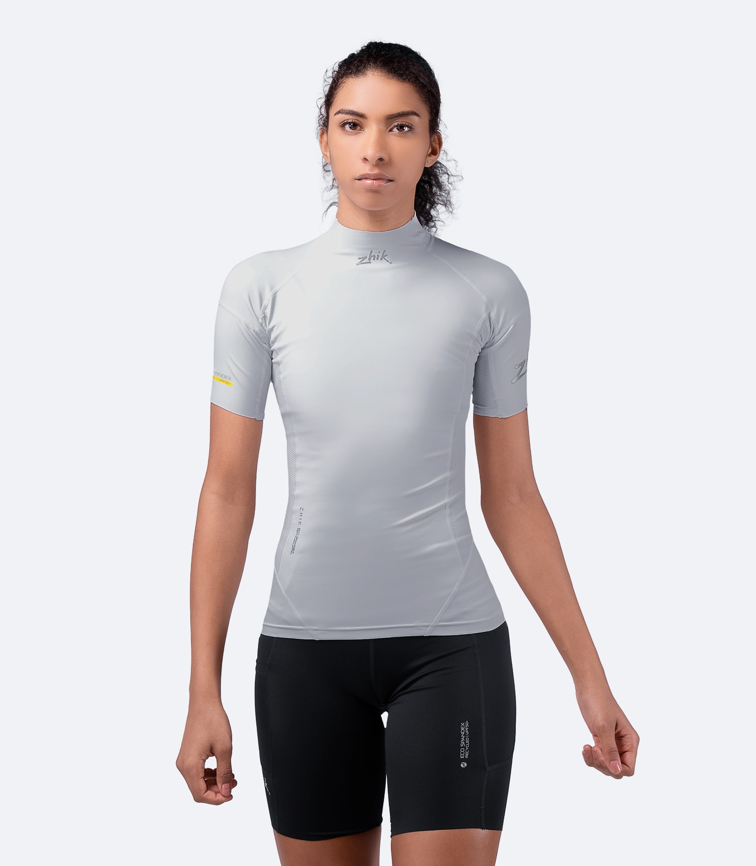 Front view of Zhik Women's Platinum Eco Spandex Top in light gray, designed with 3D body panelling for a dynamic, comfortable fit.