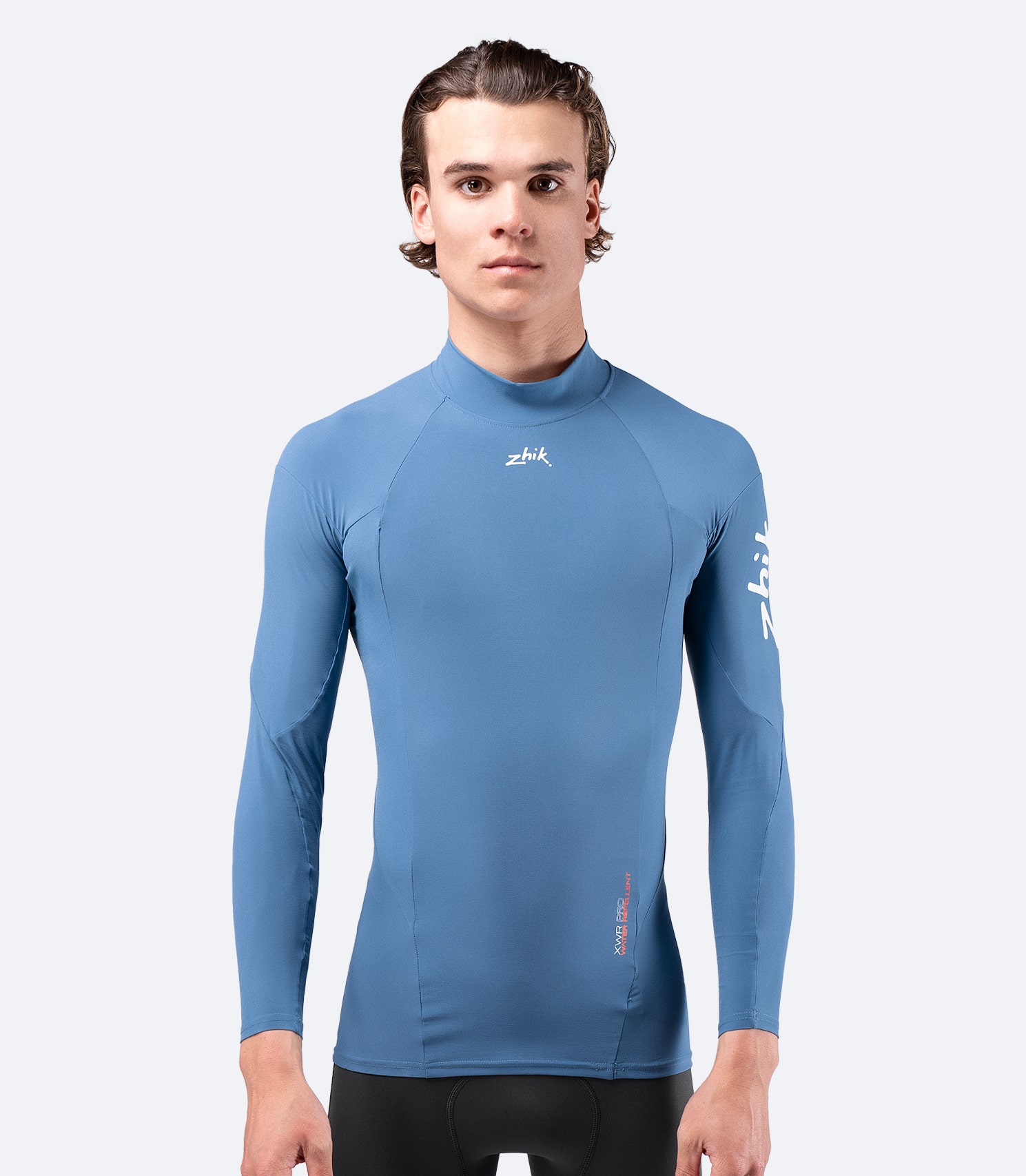 Front view of Zhik Men's XWR Pro Long Sleeve Top in deep blue, showing high collar and breathable, stretch woven fabric.