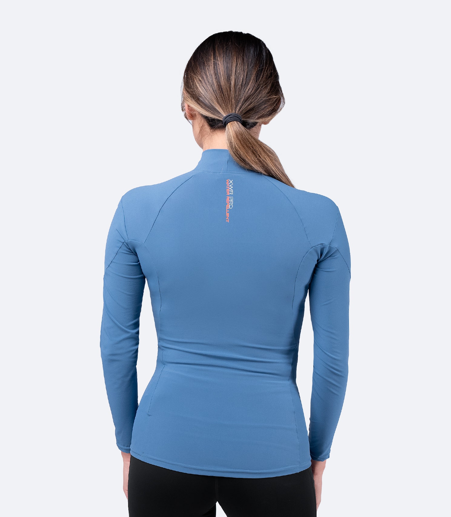 Back view of Zhik Women's XWR Pro Long Sleeve Top in Deep Blue, showing raglan cut sleeves and breathable, quick-dry water-repellent fabric.