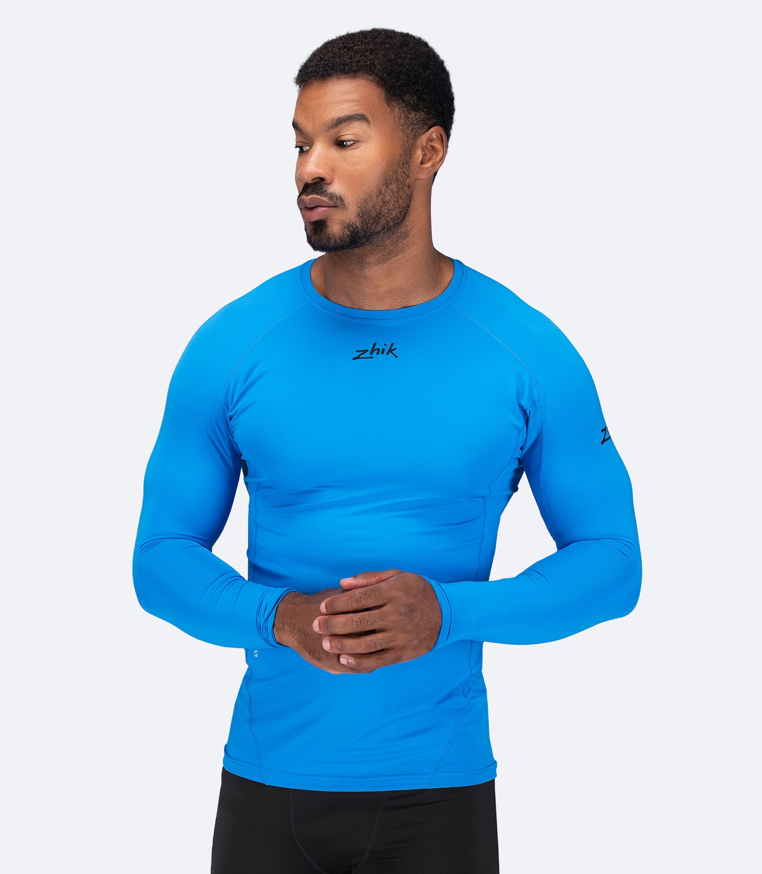 Zhik Men's Eco Spandex LT Long Sleeve Baselayer Top in Cyan, ultra-lightweight with 3D body mapped fit and UPF 50+ sun protection.